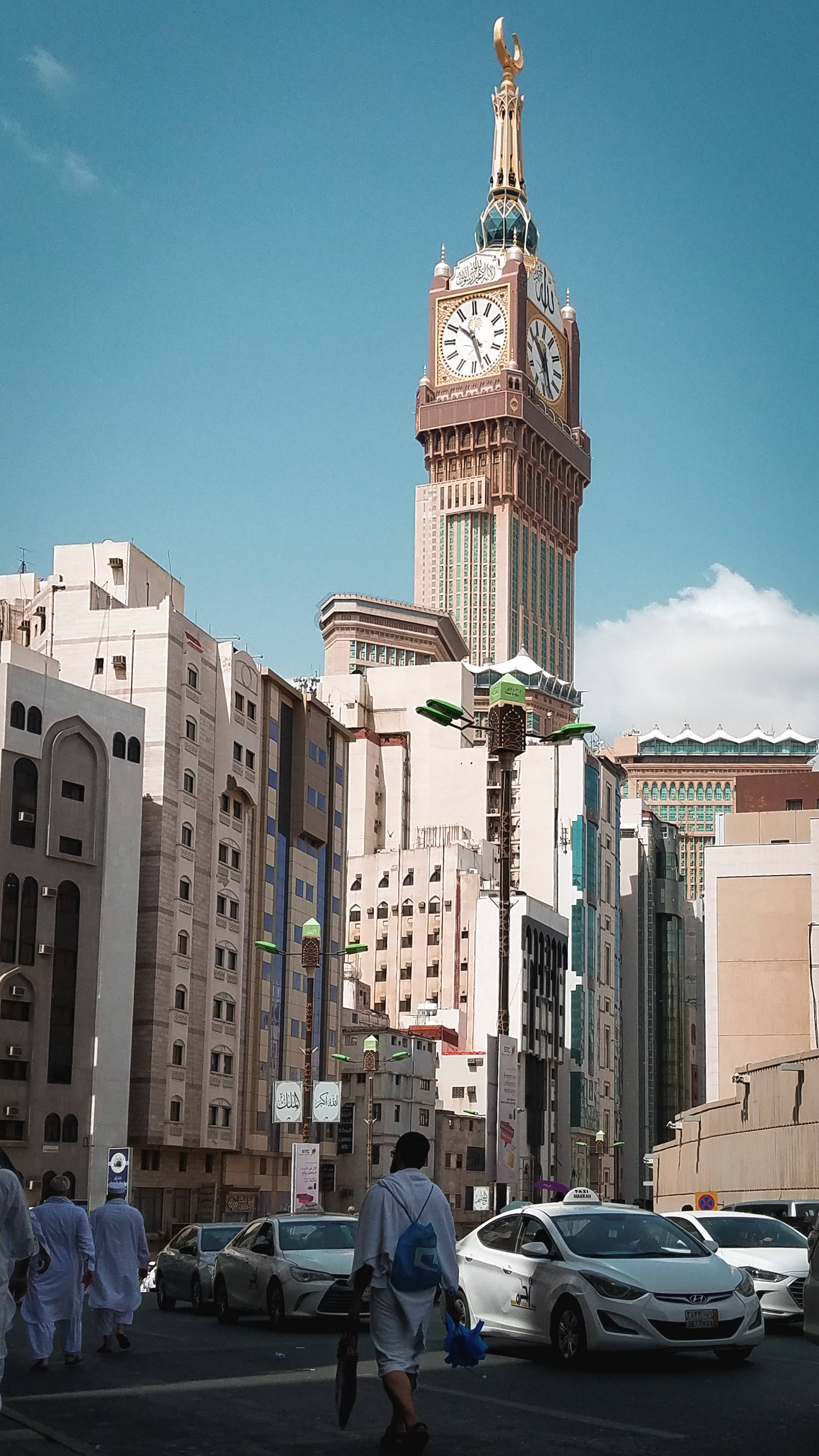 clock tower, golden crescent crown, bustling urban street, 2K Phone Wallpaper