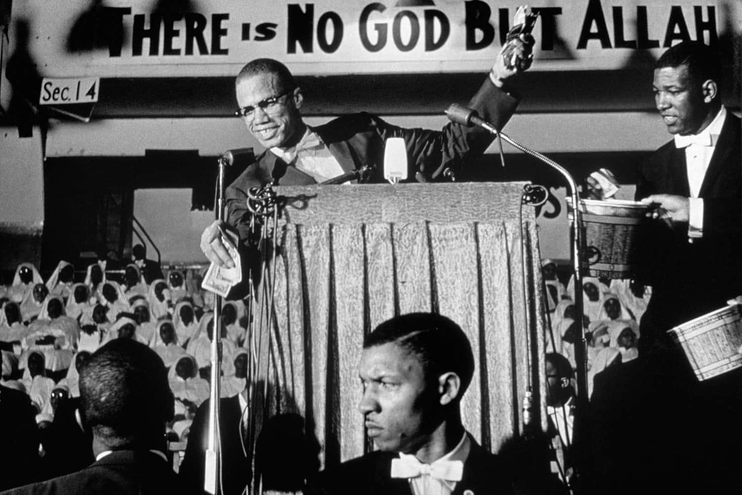 Malcolm X, podium, banner reading THERE IS NO GOD BUT ALLAH, HD Desktop Wallpaper