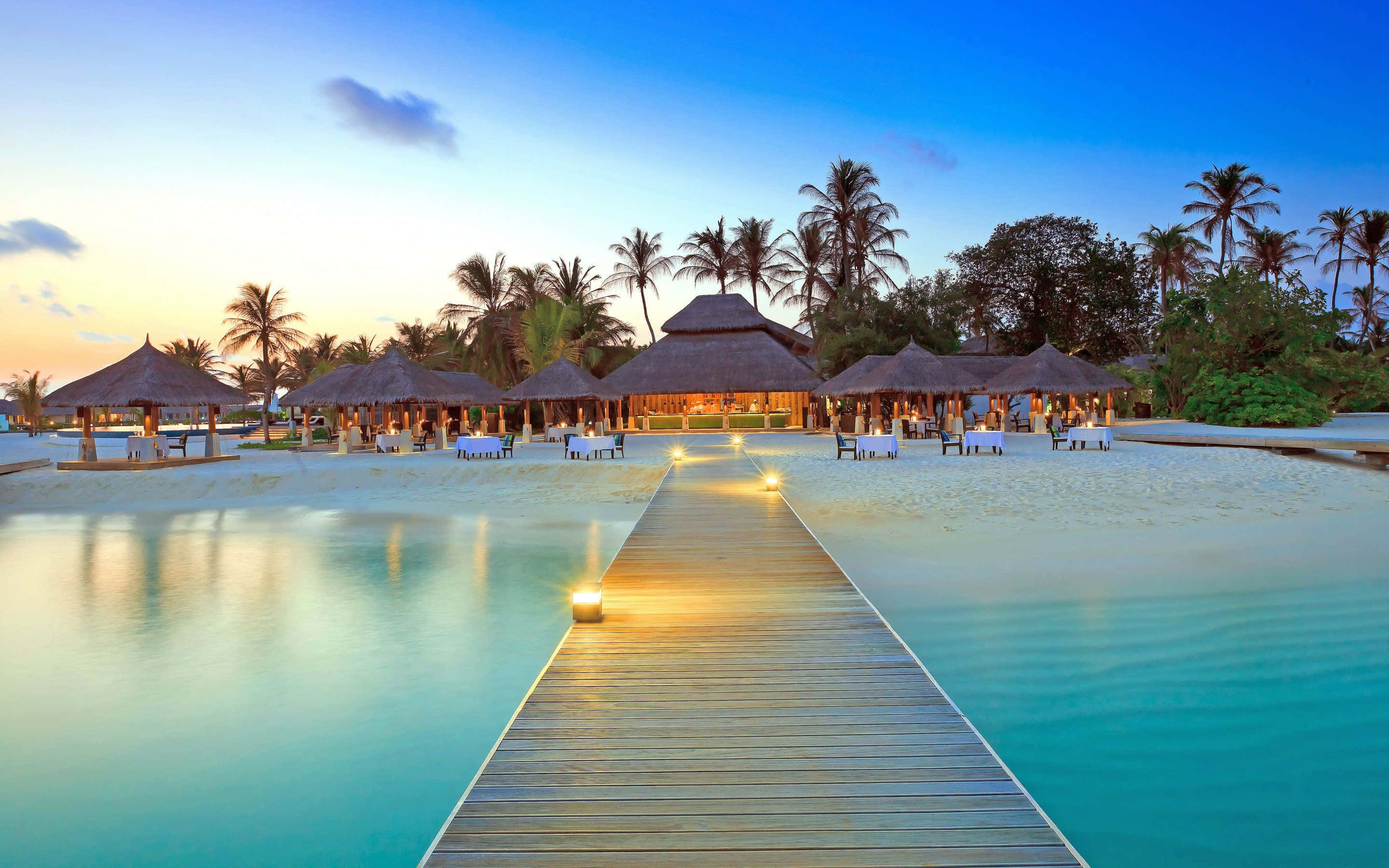 Maldives Beach, turquoise water, thatched-roof huts, 2K Desktop Wallpaper