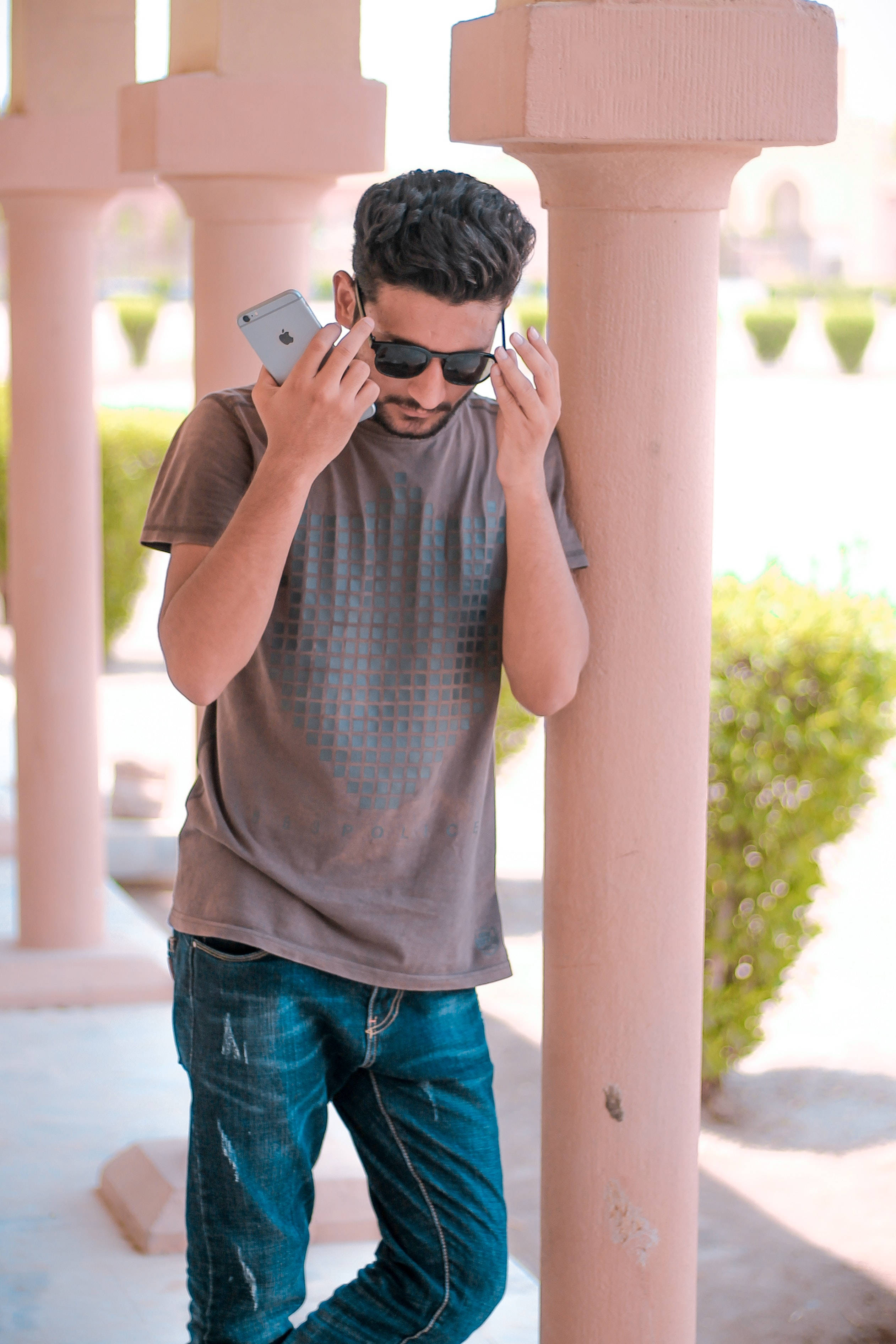 iPhone, brown tshirt, pink columns, 2K Phone Wallpaper