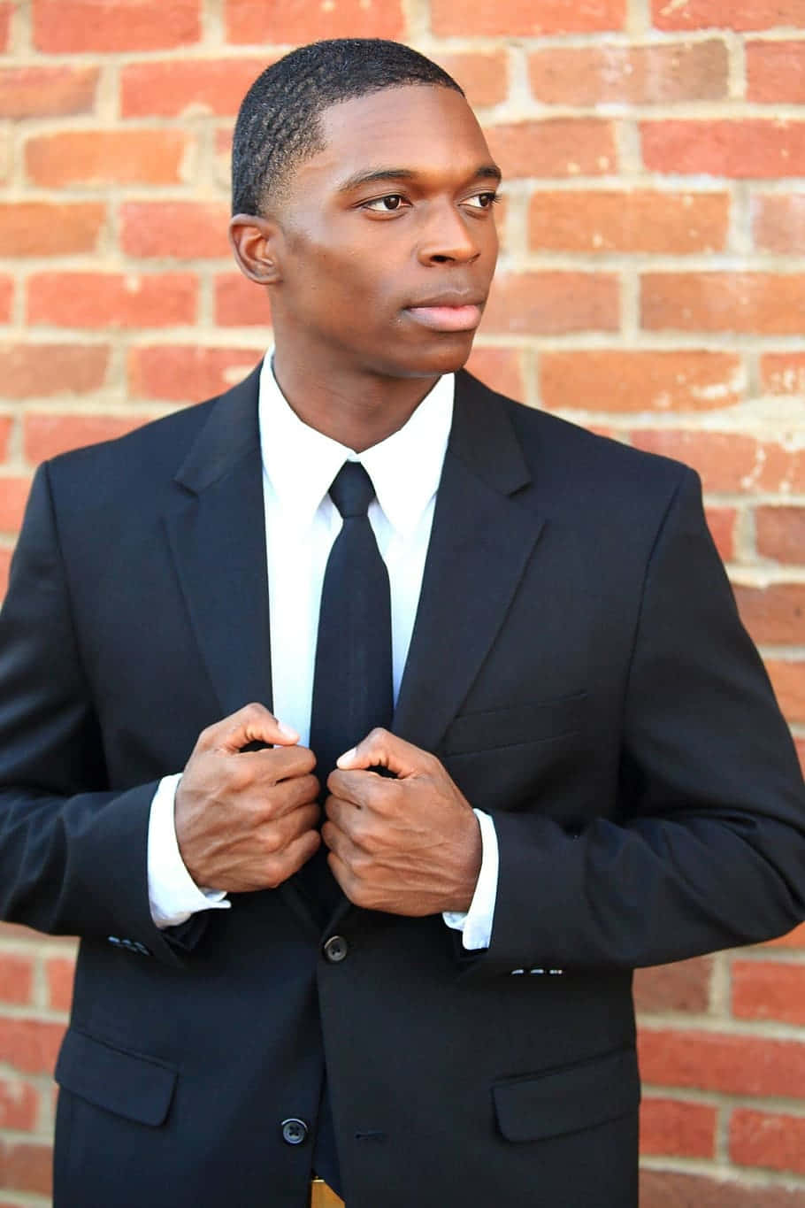 black suit, textured red brick wall, young man, HD Phone Wallpaper