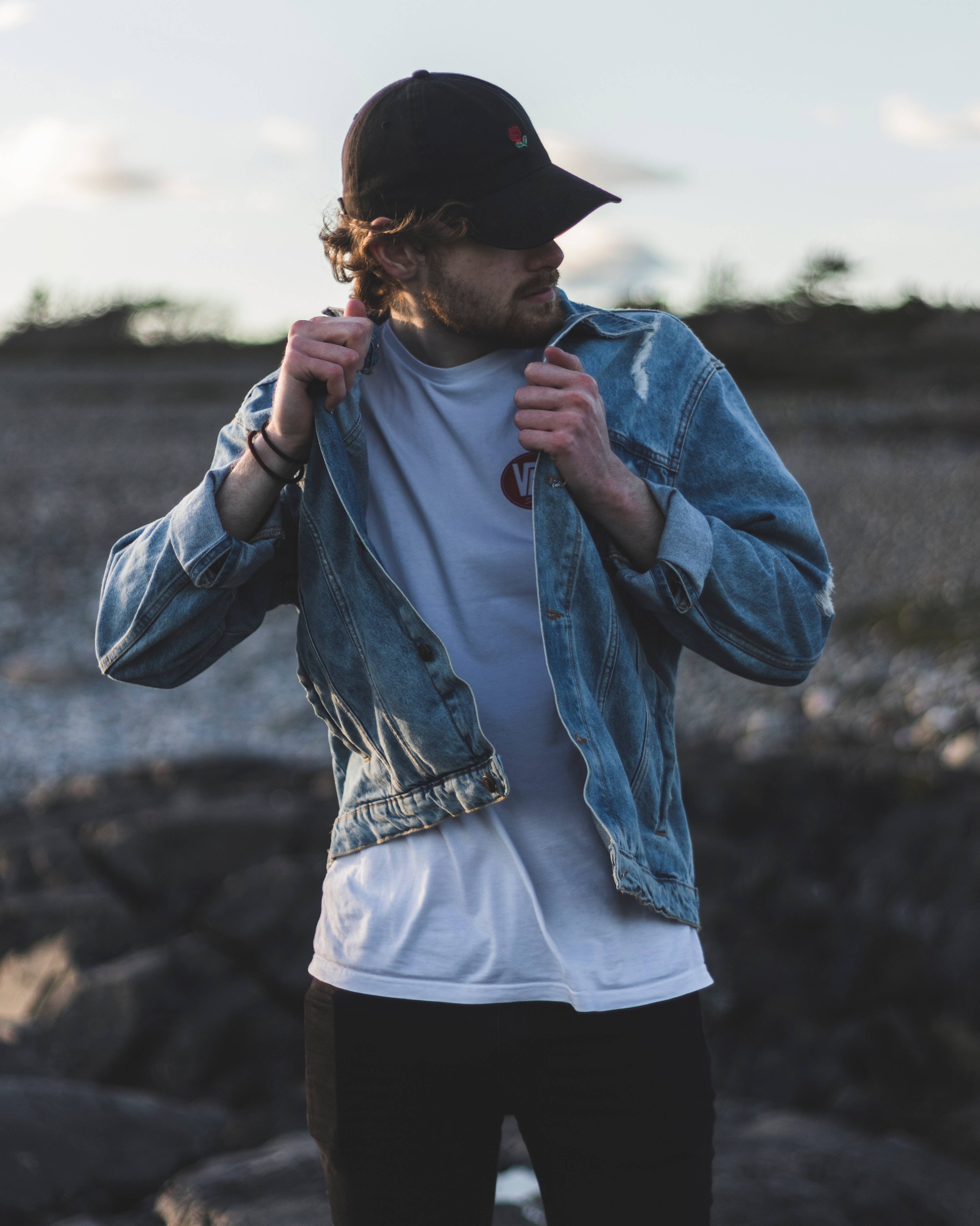 male model, black cap, curly hair, 4K Phone Wallpaper