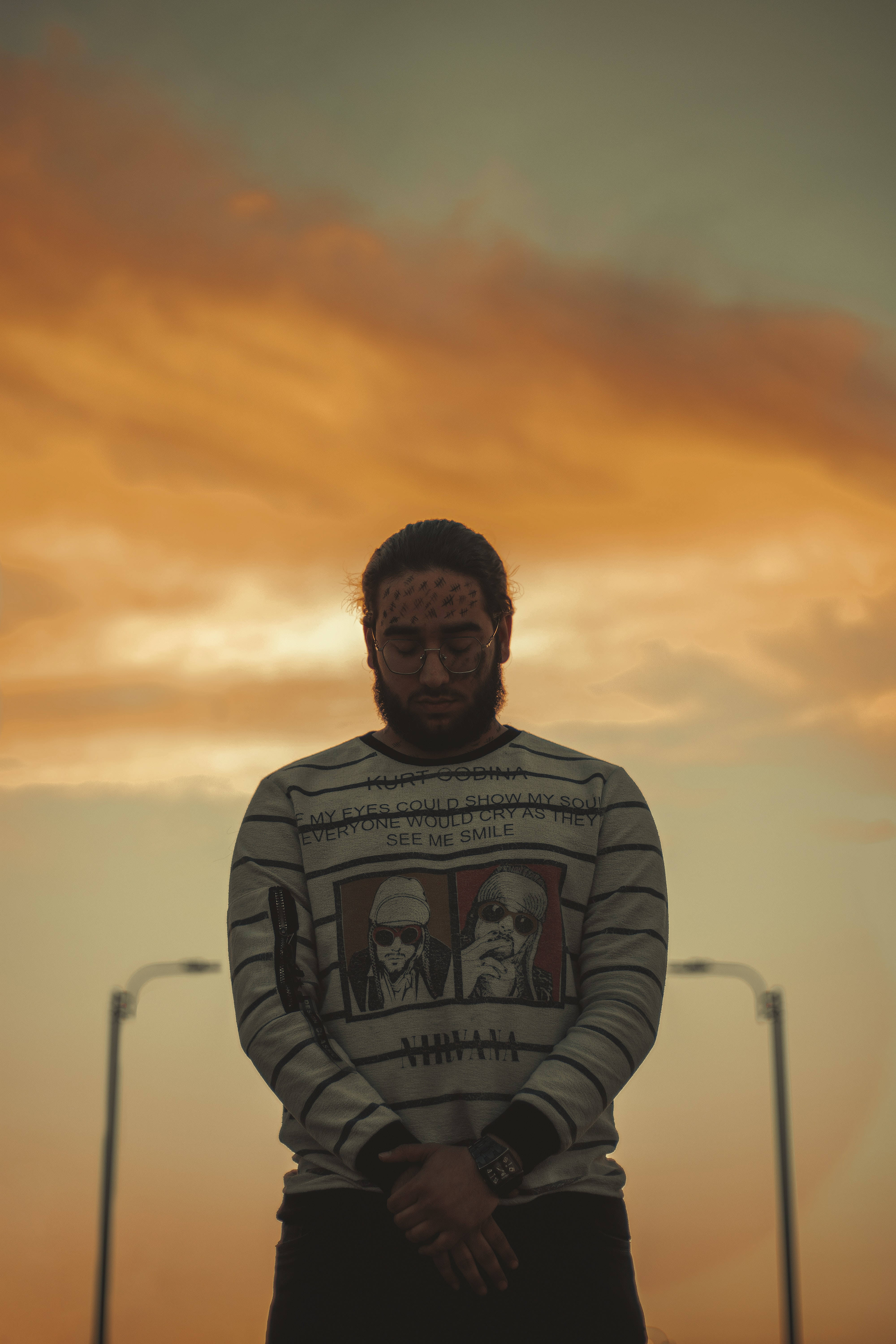 Male Pose, vibrant orange and yellow sunset sky, streetlights, 5K Phone Wallpaper