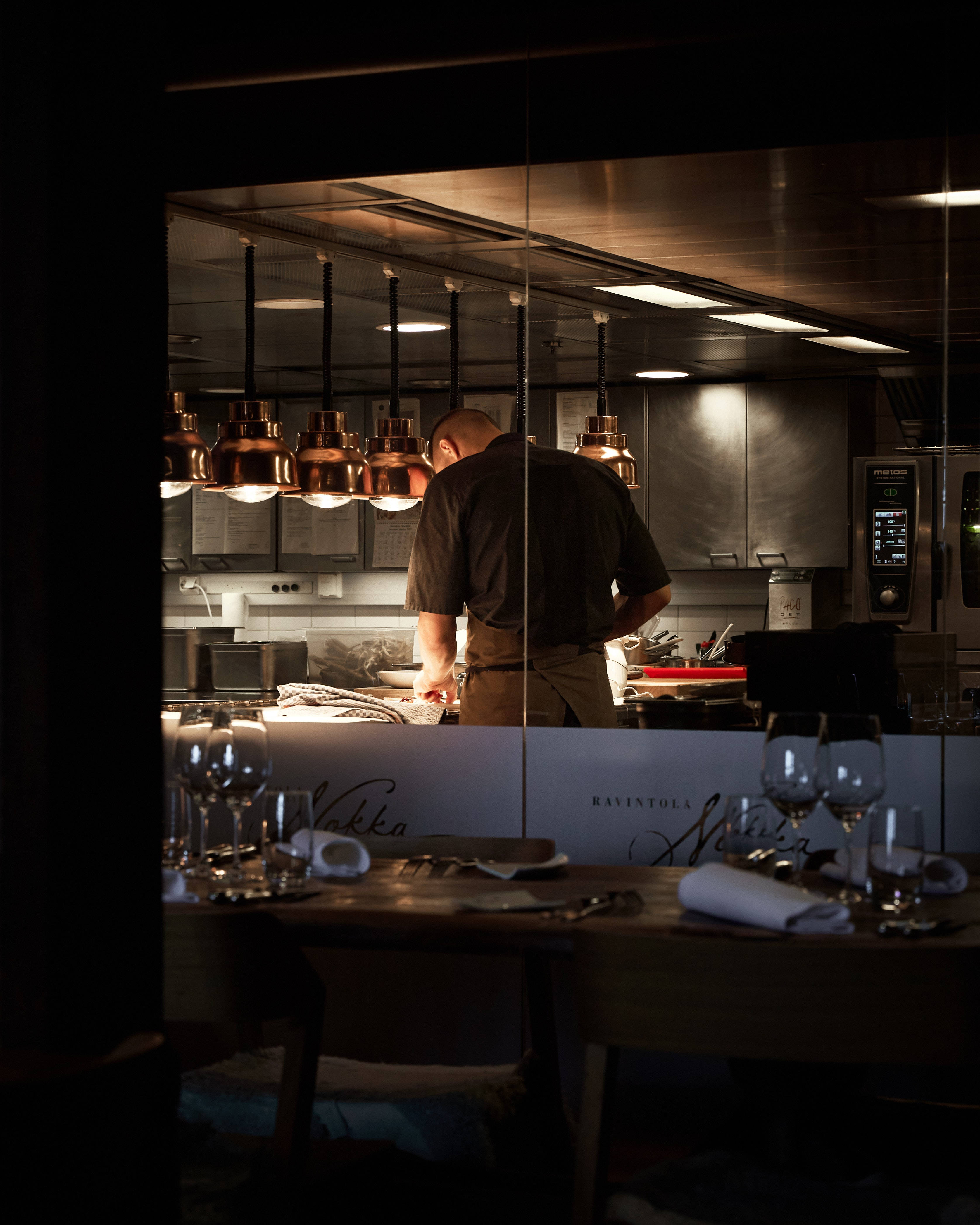Chef Man Aesthetic, dimly lit modern kitchen, copper pendant lights, 4K Phone Wallpaper