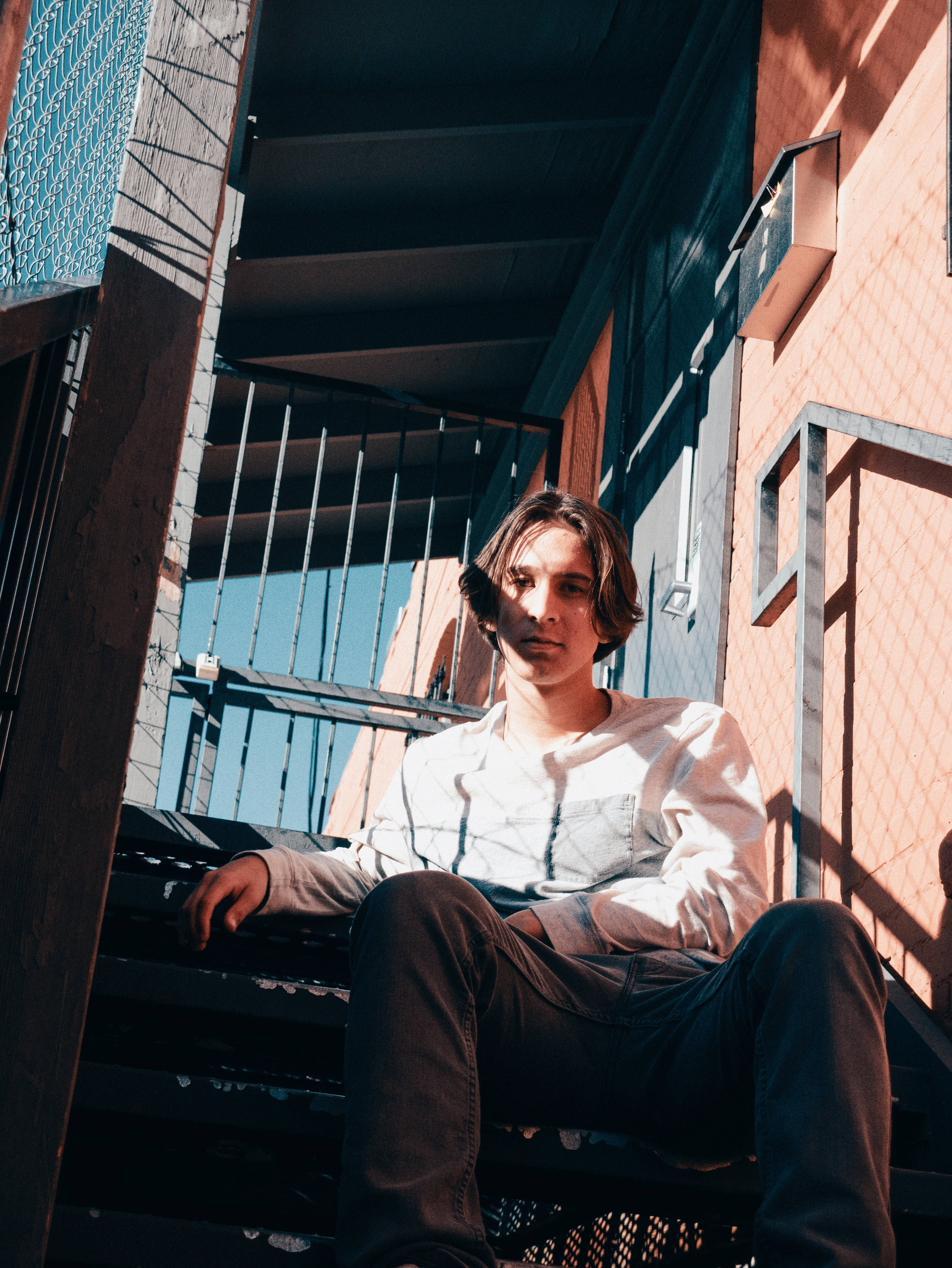 metal stairs, warm sunlight, brick walls, 4K Phone Wallpaper