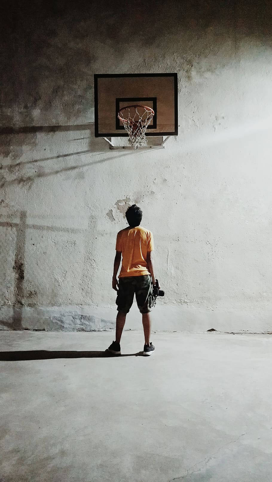 basketball hoop, orange shirt, dimly lit concrete gym, HD Phone Wallpaper
