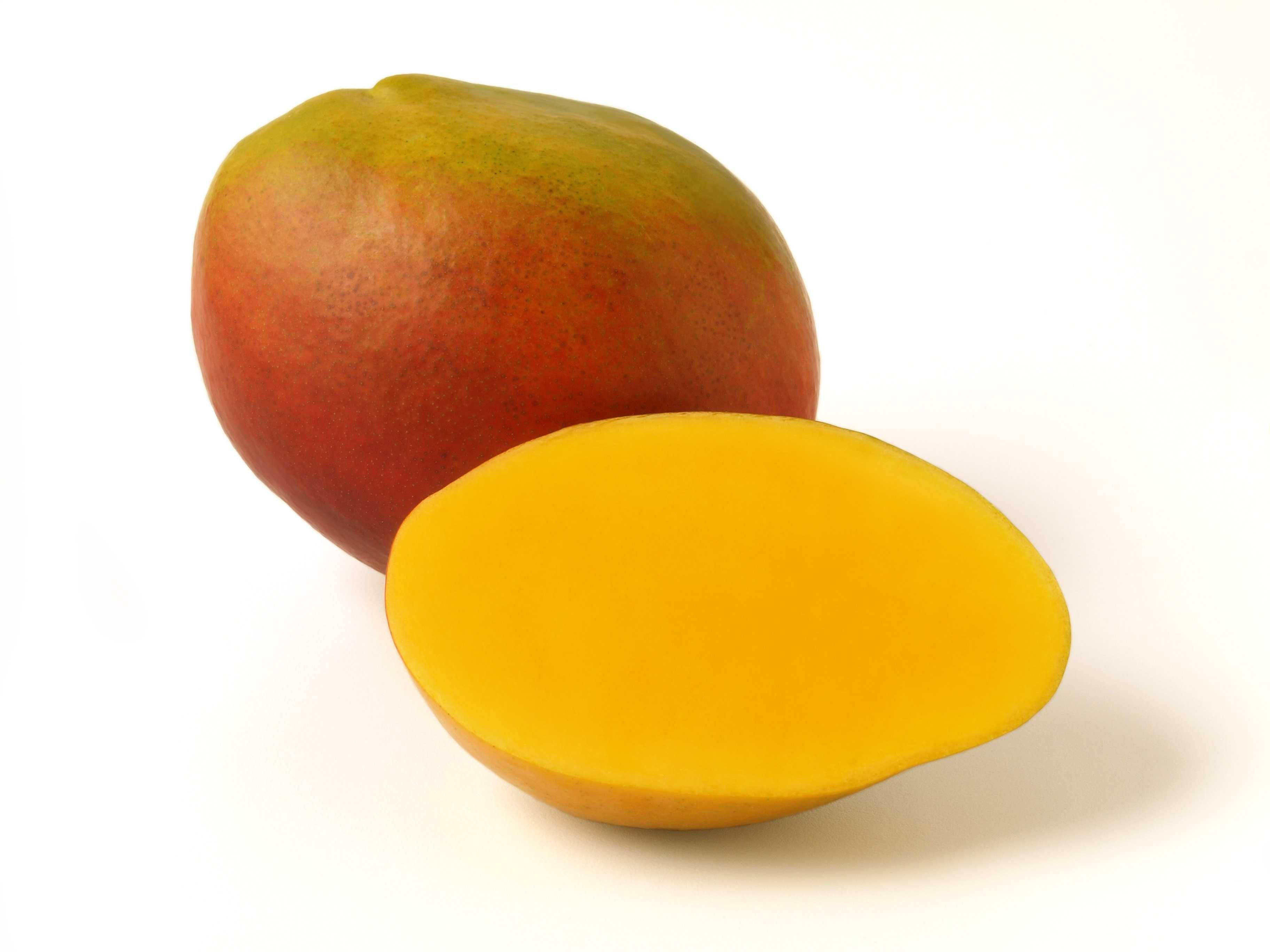 whole ripe mango fruit, sliced half, vibrant yellow flesh, 2K Desktop Wallpaper