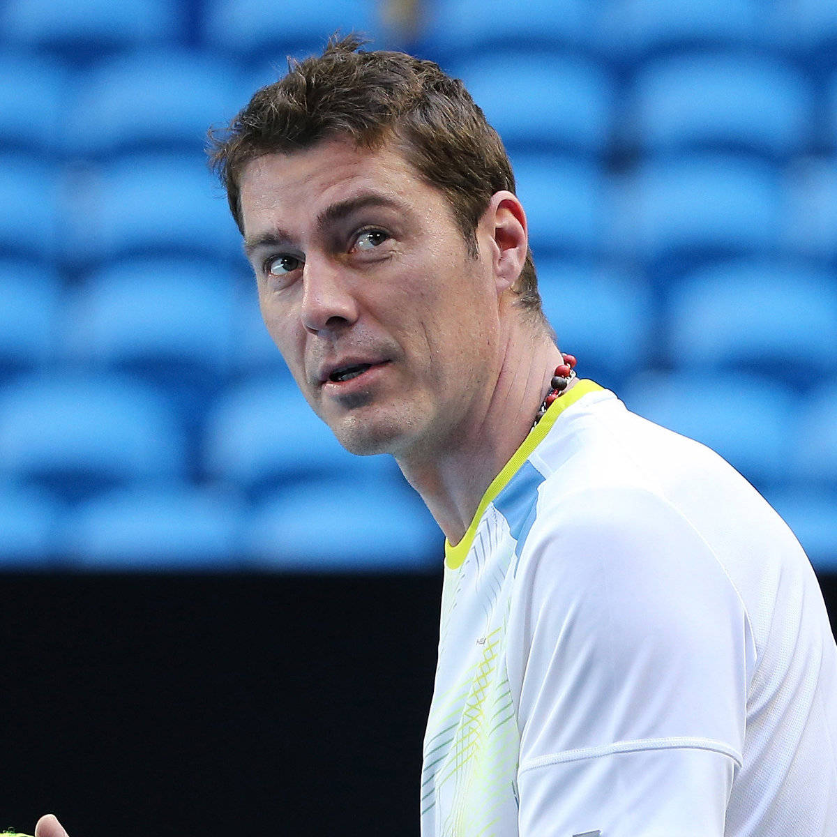 Marat Safin, white shirt with yellow trim, blue stadium seats, SD Desktop Wallpaper