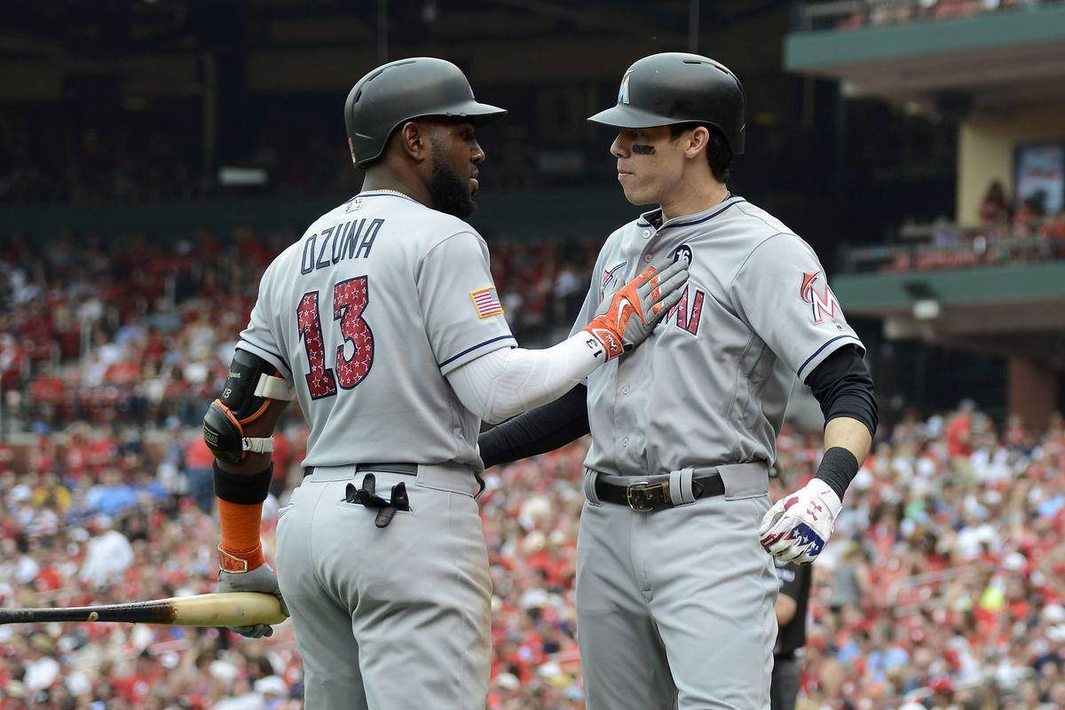 Marcell Ozuna, tapping teammate's chest, gray uniforms, SD Desktop Wallpaper