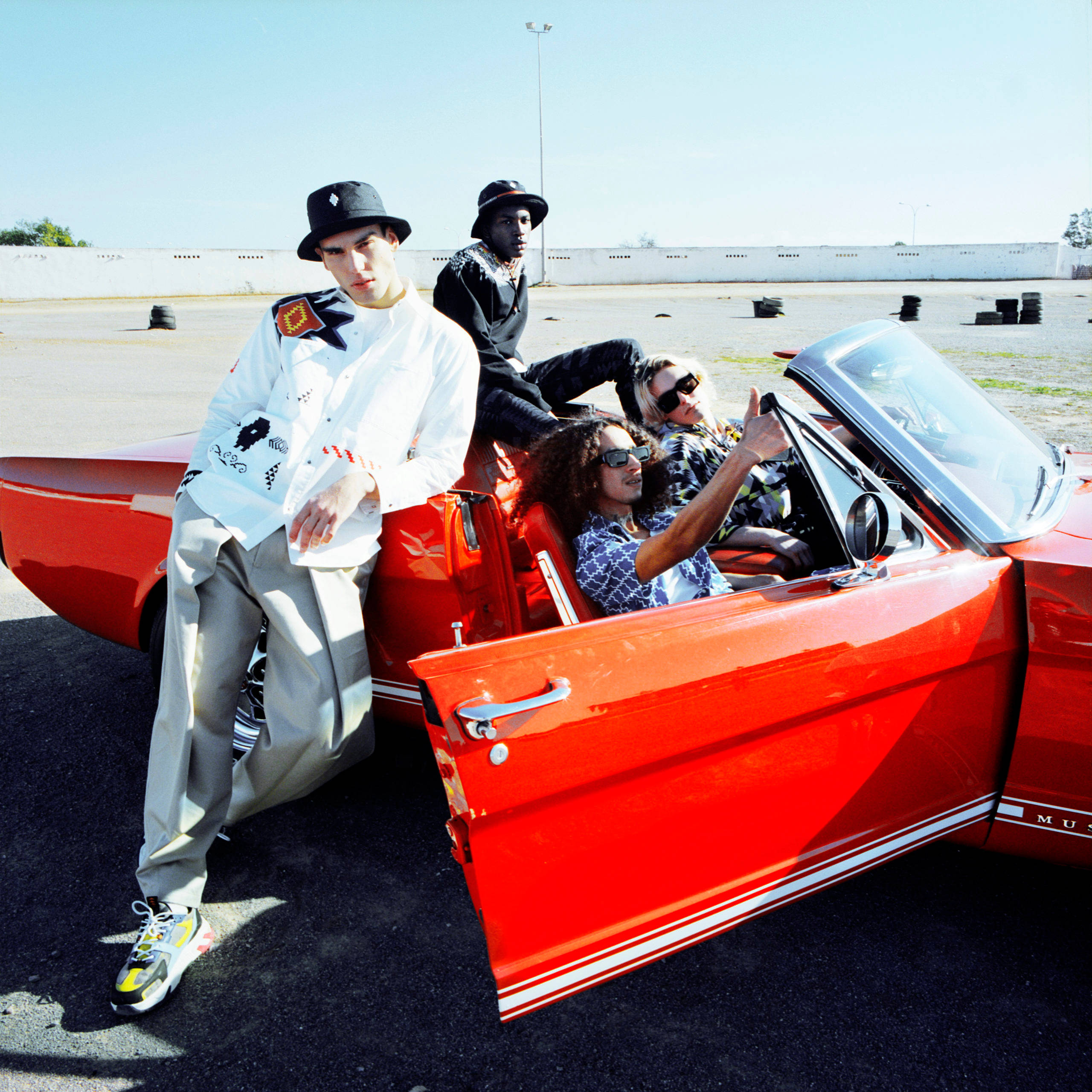 Marcelo Burlon, vibrant red classic convertible, bright daylight, 2K Desktop Wallpaper