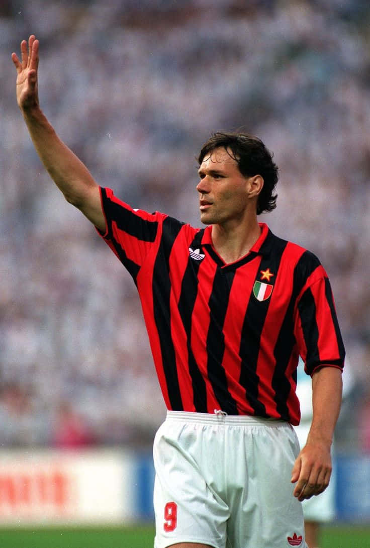 Marco Van Basten, red and black striped jersey, sunlit stadium field, SD Phone Wallpaper