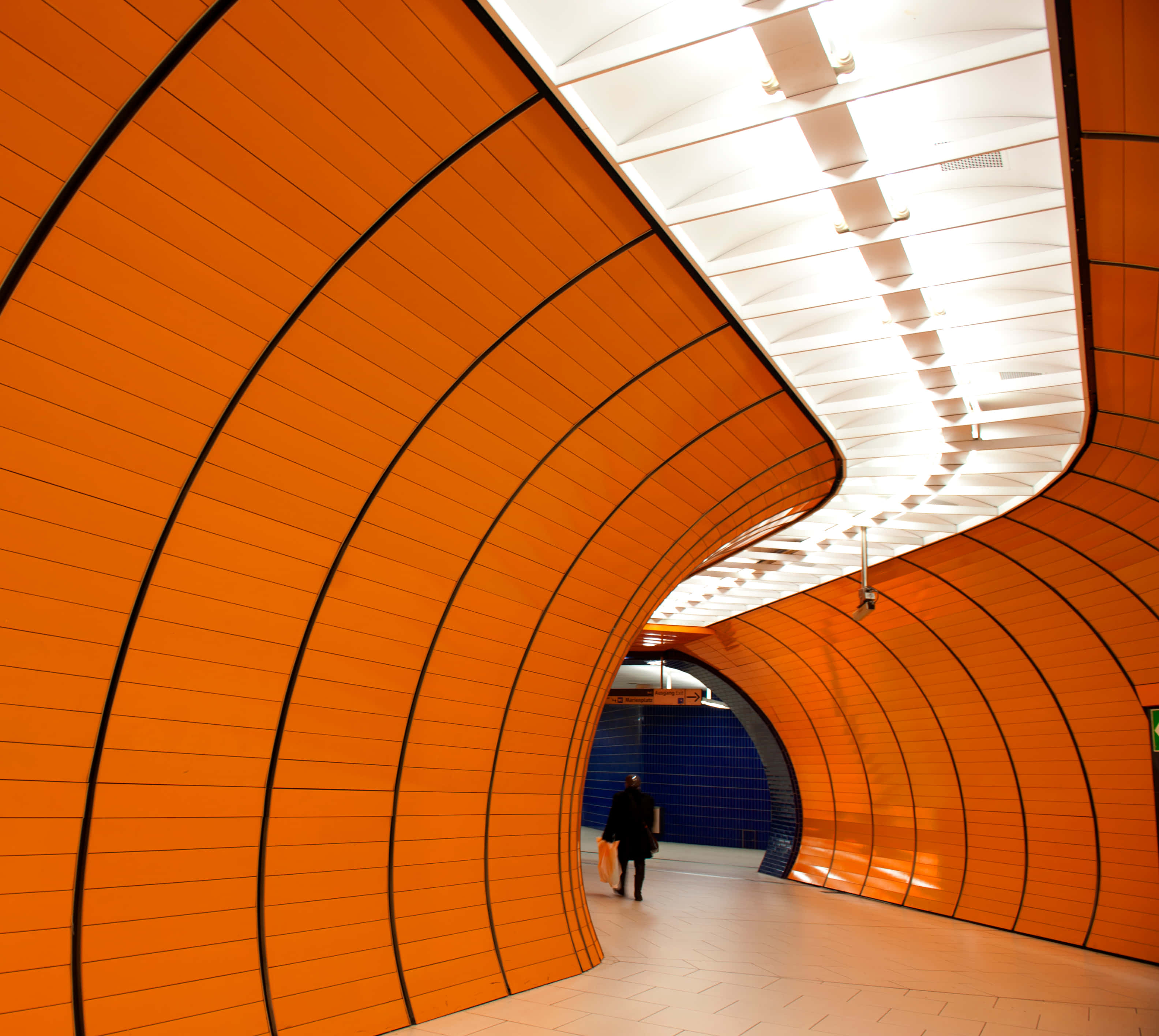 Marienplatz, vibrant orange, curved subway tunnel, 2K Desktop Wallpaper