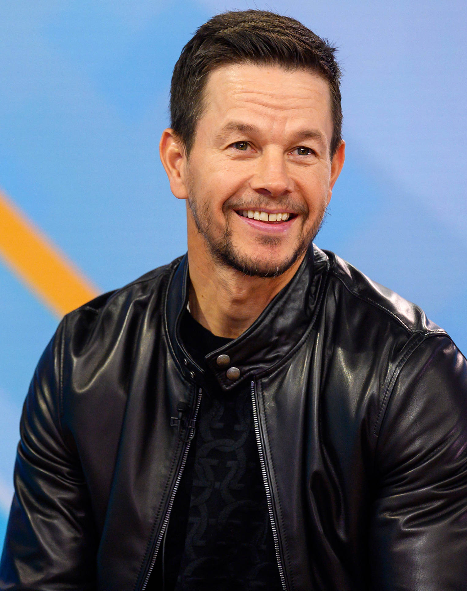 Mark Wahlberg, black leather jacket, blue and yellow background, Full HD Phone Wallpaper