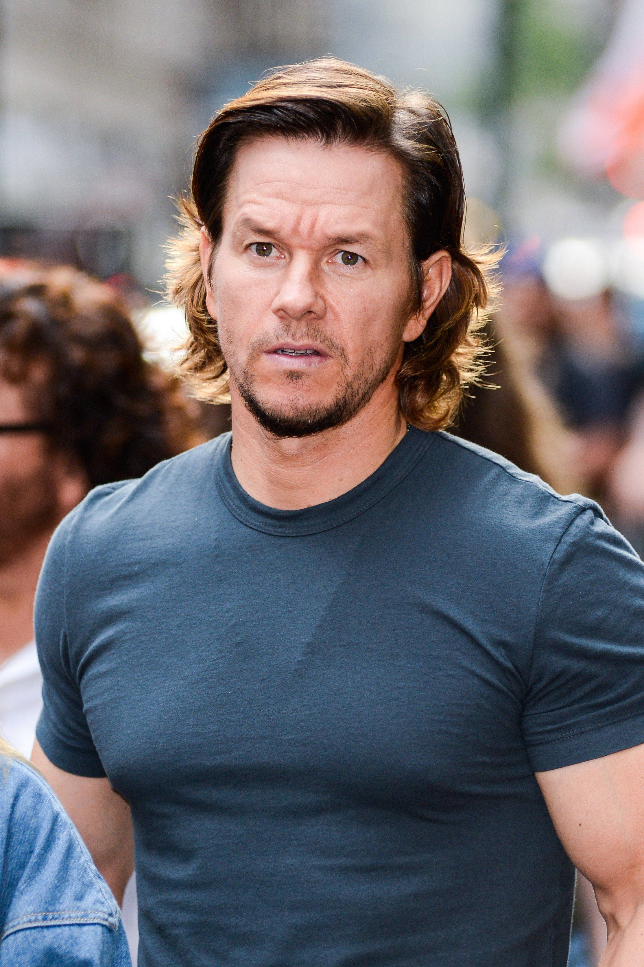 Mark Wahlberg, dark blue t-shirt, crowded urban street, 2K Phone Wallpaper