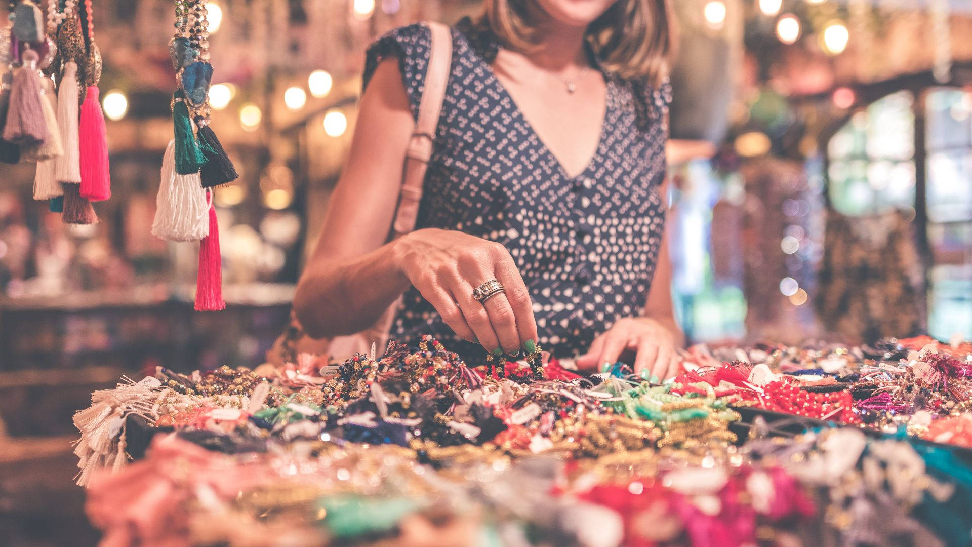 handmade jewelry, warmly lit market stall, hanging tassels, Full HD Desktop Wallpaper