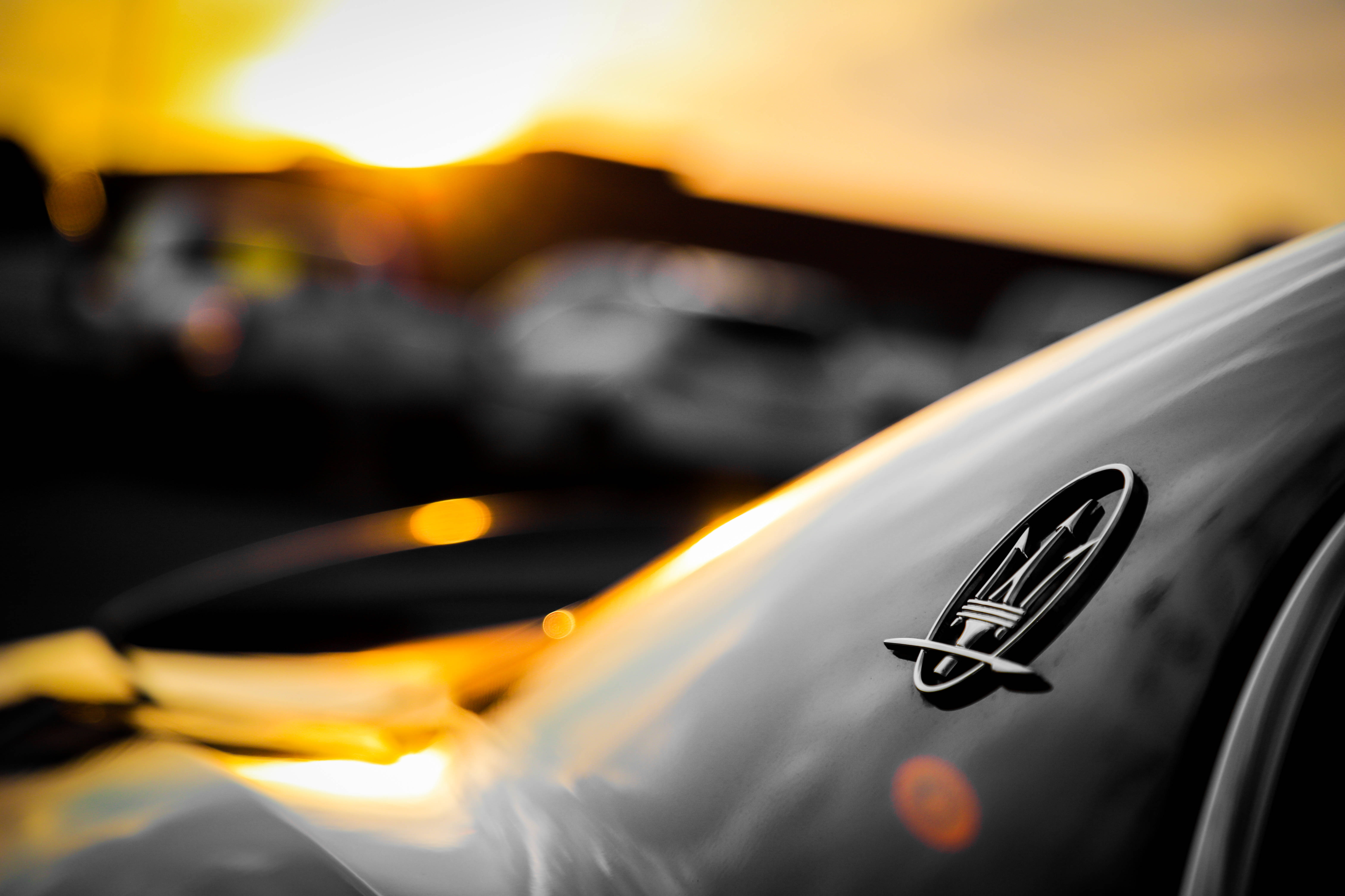 Maserati, sleek black car, golden sunset glow, 5K Desktop Wallpaper