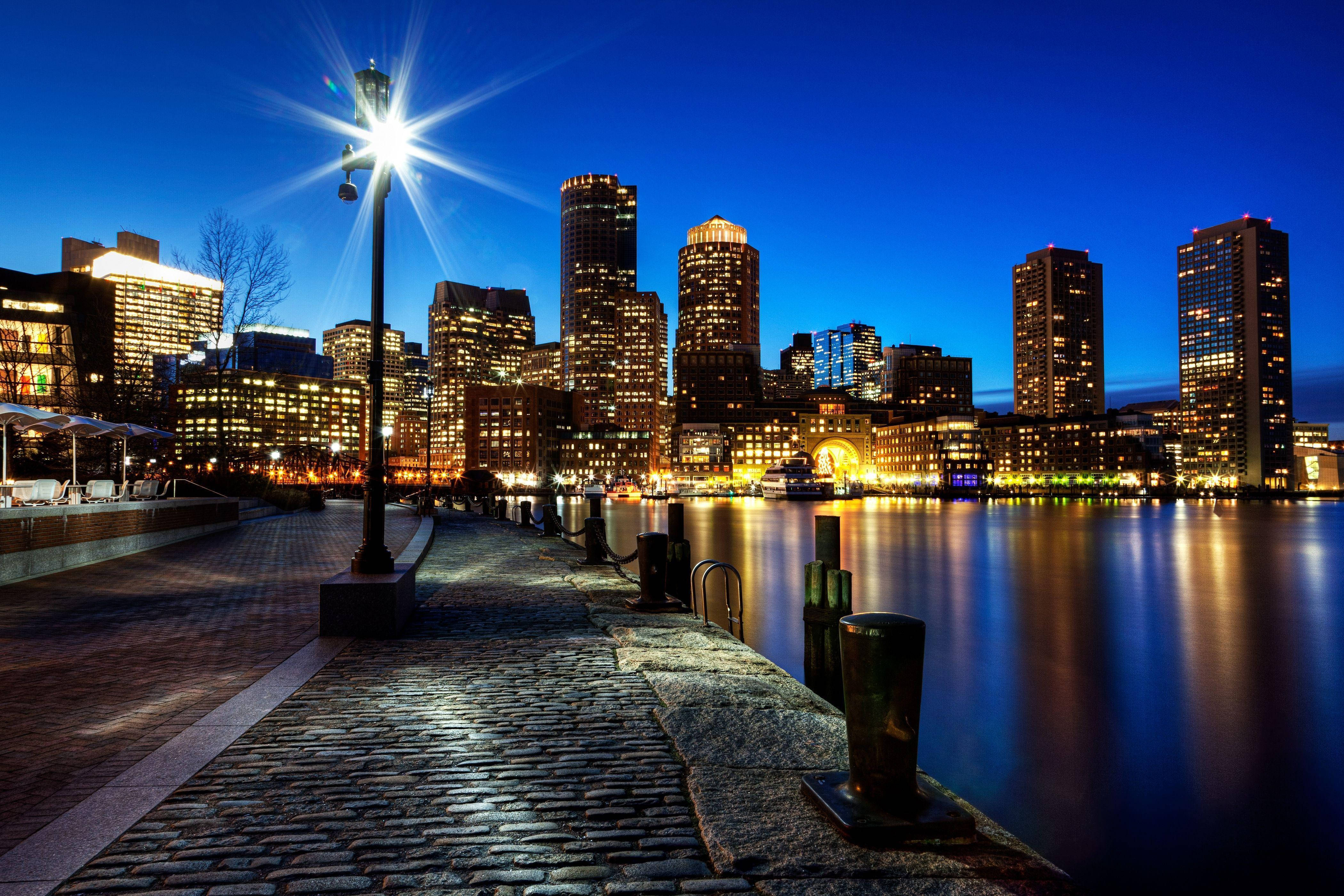 MA Night Time City Shoreline, cobblestone waterfront path, glowing city skyline, 4K Desktop Wallpaper