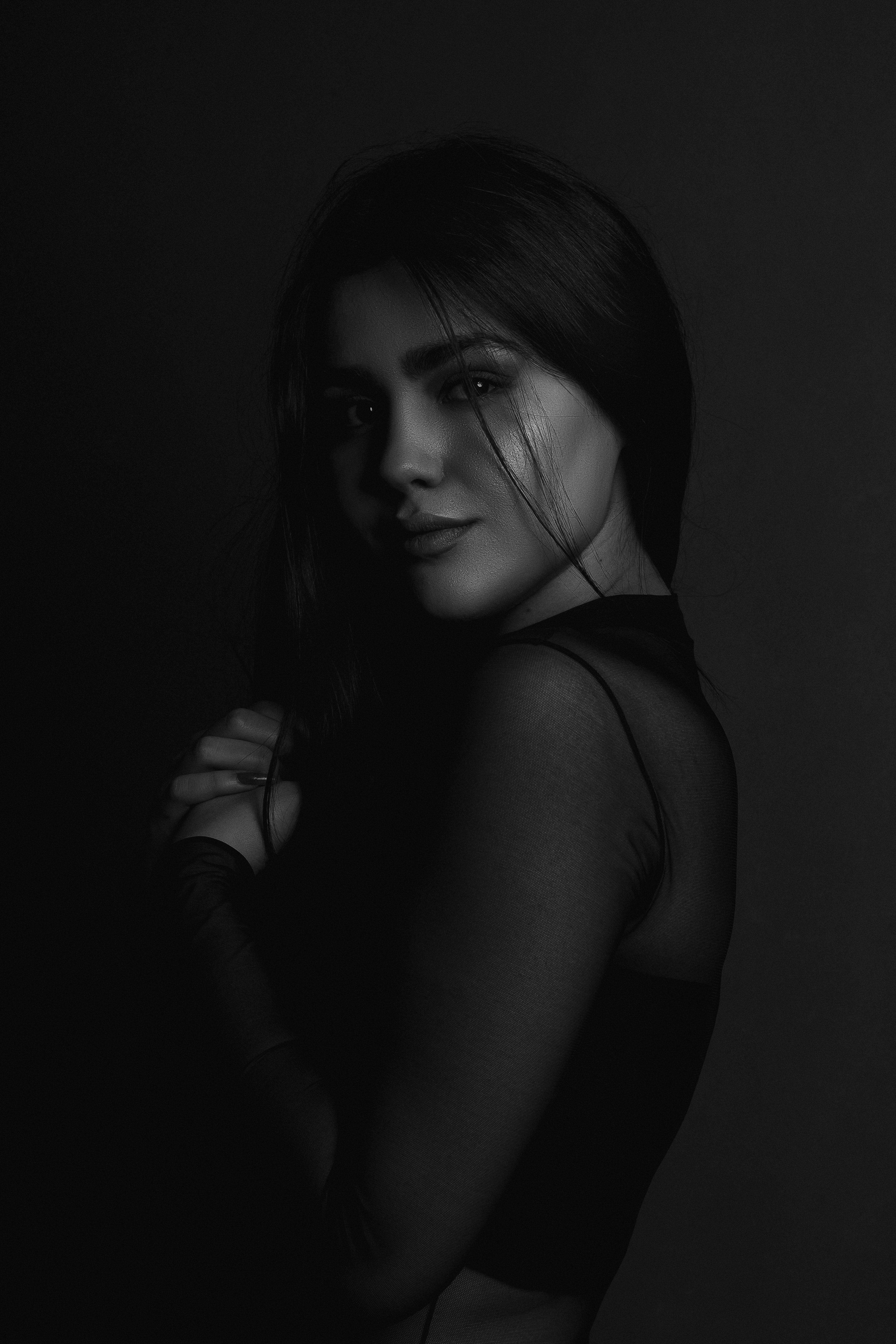 mysterious mature woman, dark hair, high-contrast black and white, 5K Phone Wallpaper