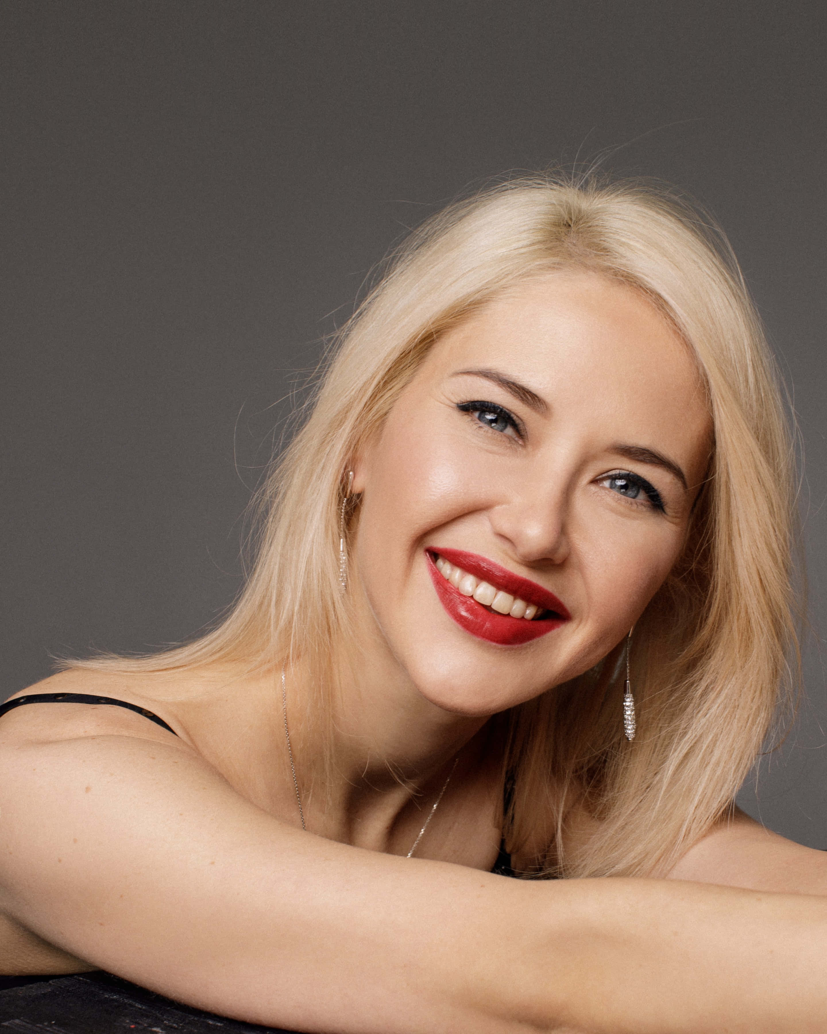 blonde woman, bold red lipstick, neutral gray studio backdrop, 2K Phone Wallpaper
