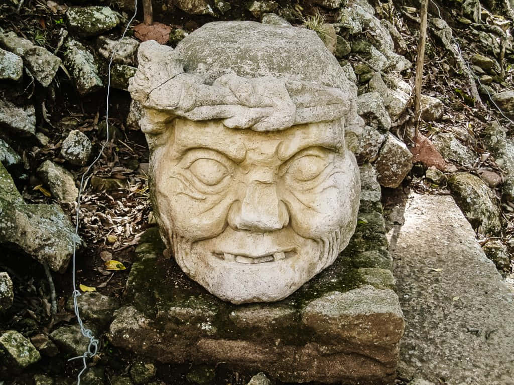 Mayan Ruins of Copan, gargoyle head, mossy rock, SD Desktop Wallpaper