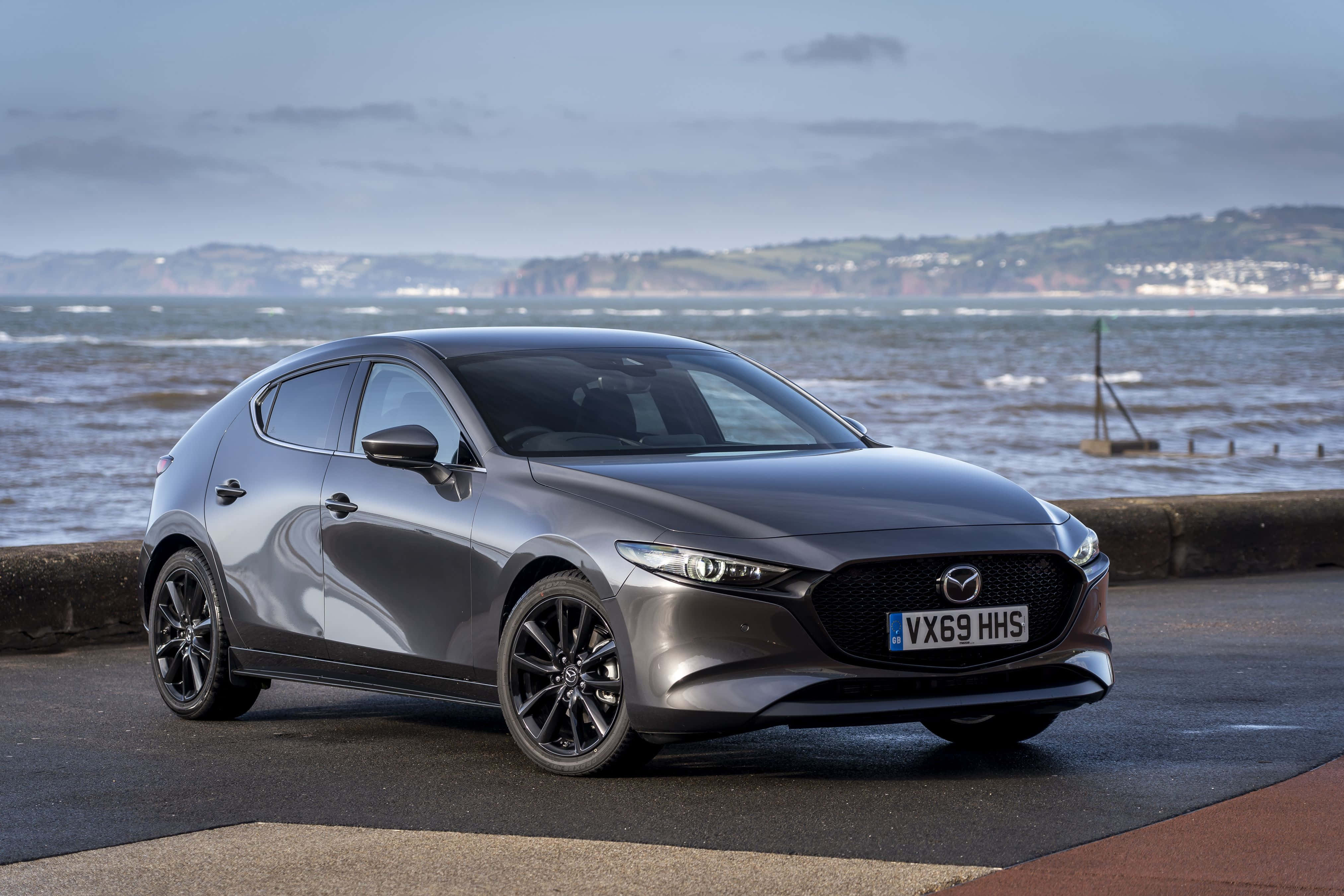 Mazda 3 Hatchback, sleek gray, coastal road, 4K Desktop Wallpaper
