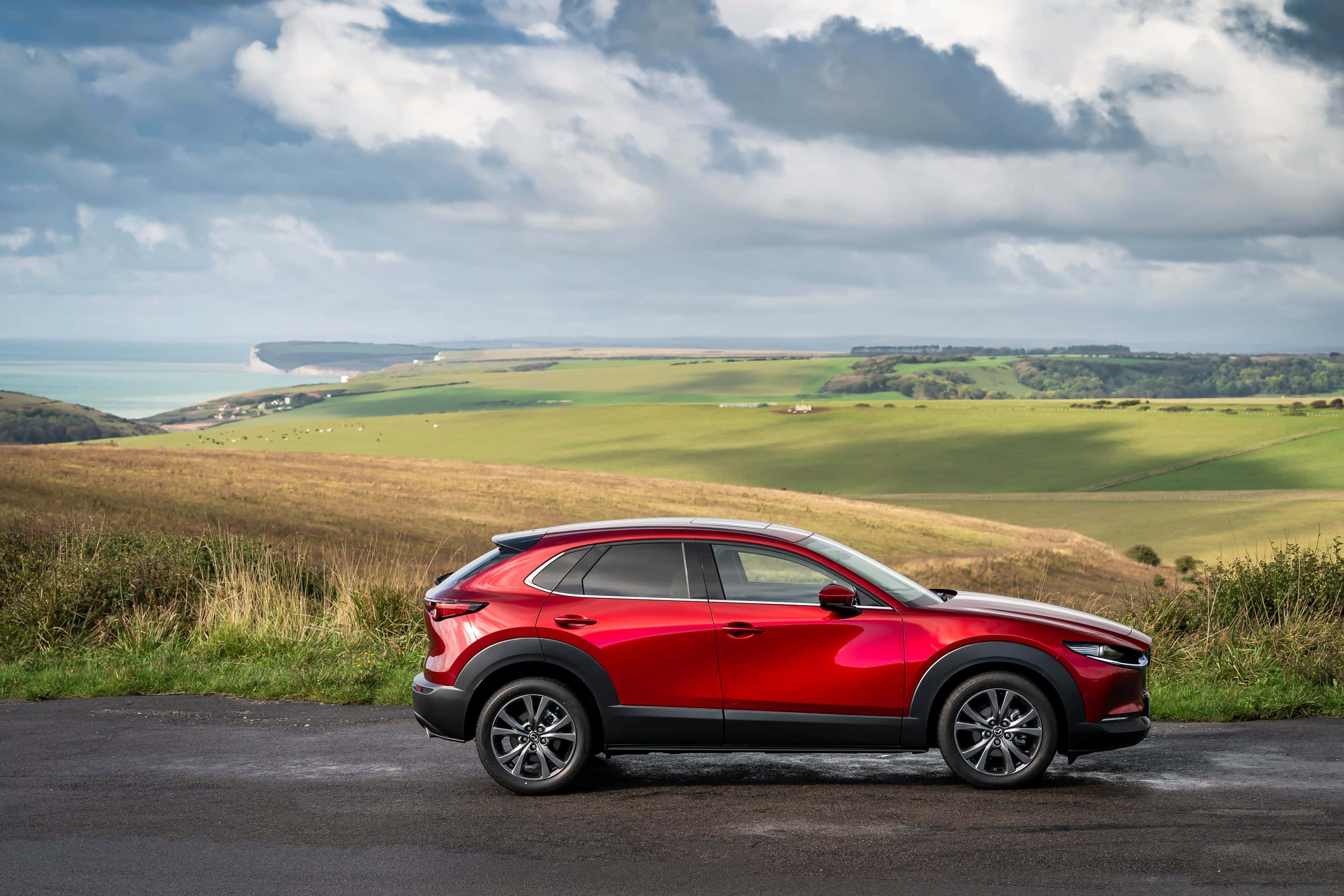Mazda CX-30, glossy red, coastal road, 2K Desktop Wallpaper