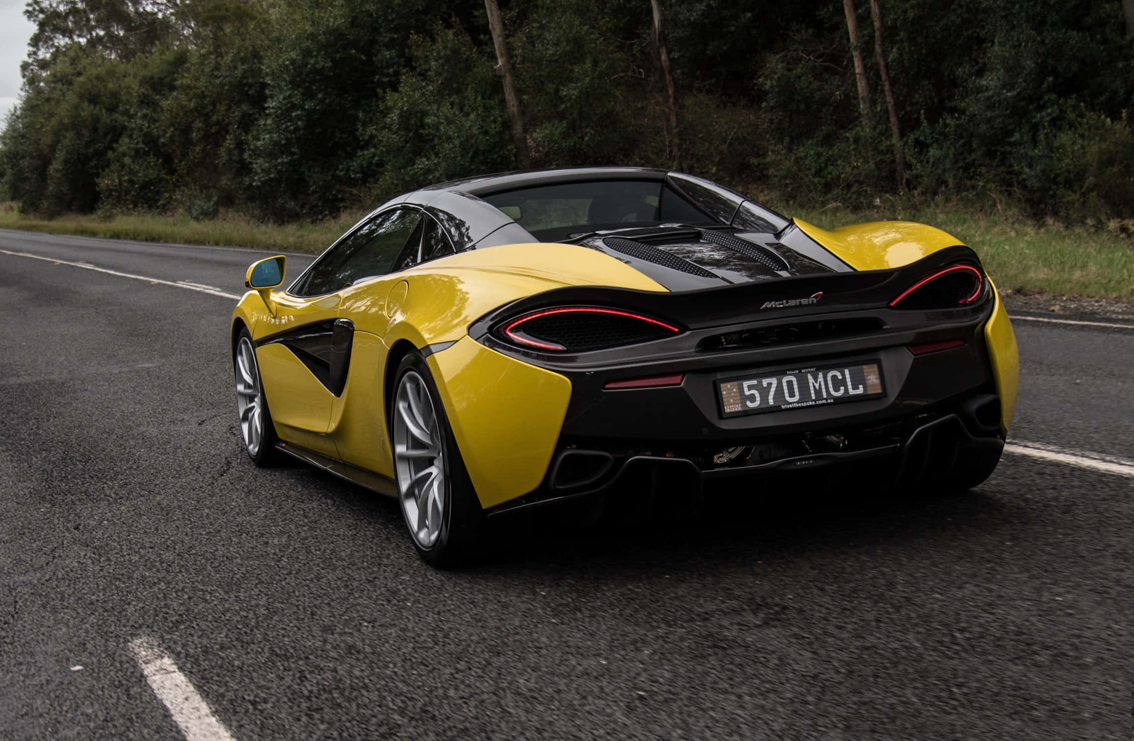 McLaren 570s, vibrant yellow, tree-lined asphalt road, Full HD Desktop Wallpaper