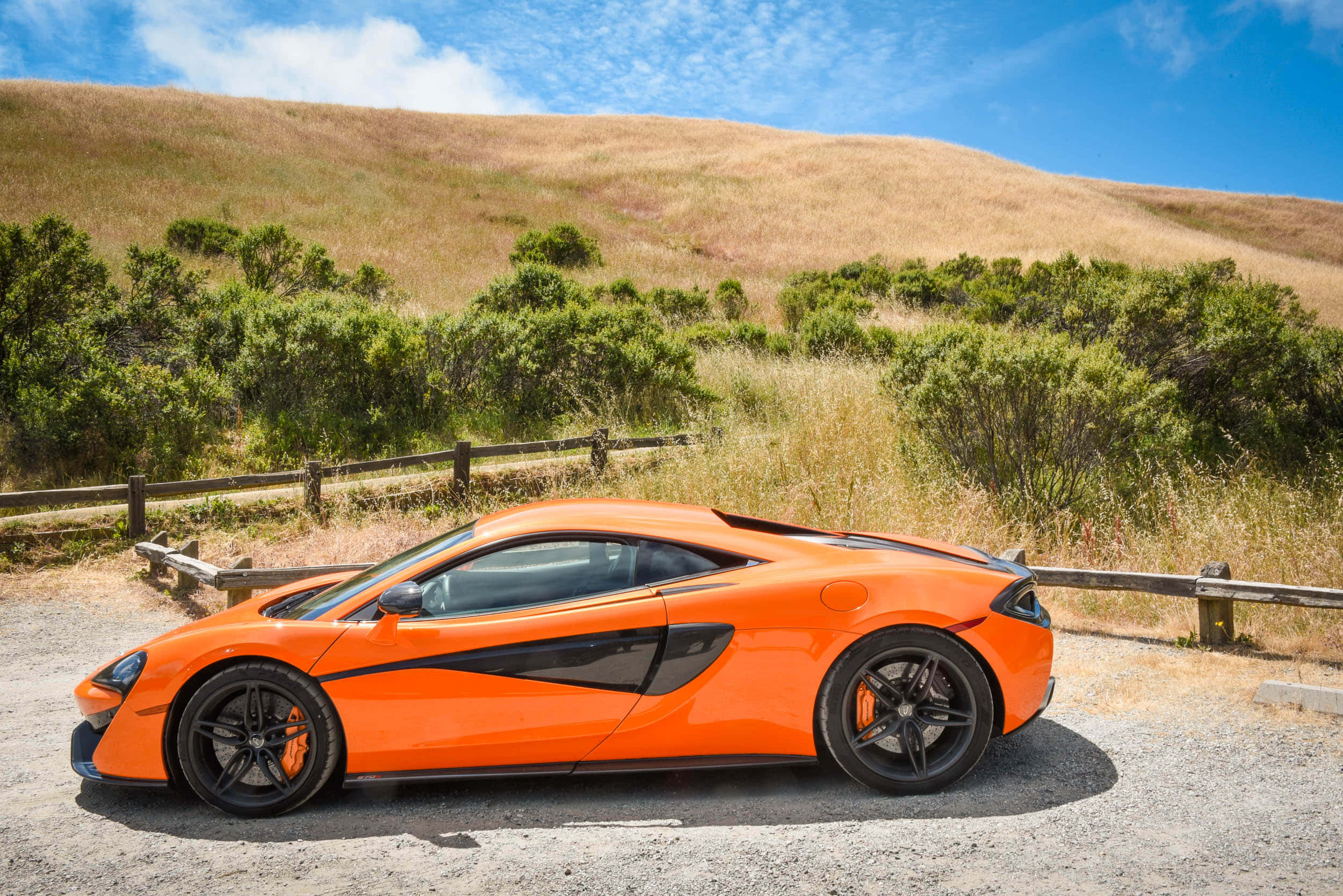 McLaren 570s, vibrant orange, gravel road, Full HD Desktop Wallpaper