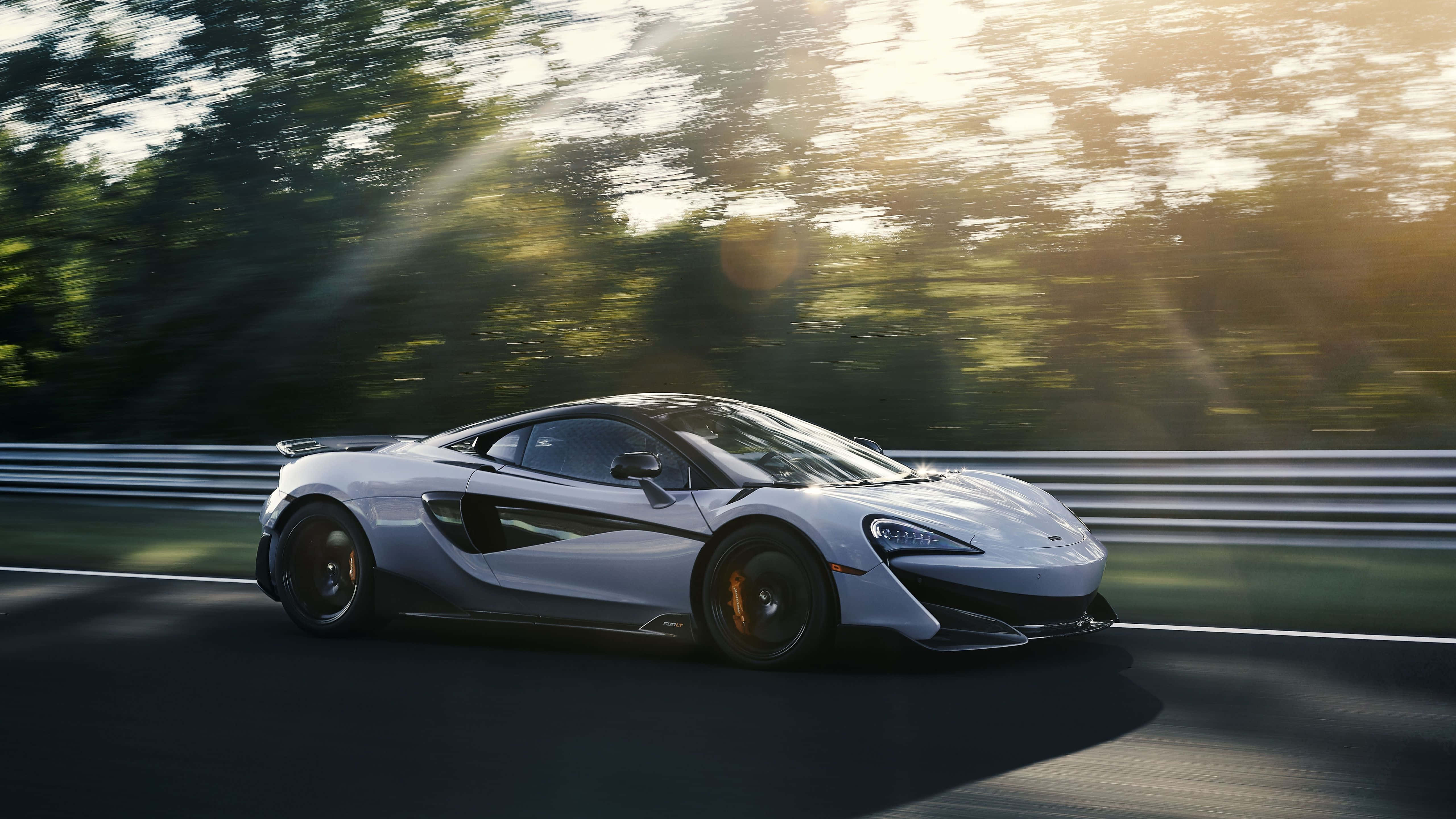 McLaren 600LT, silver, forest-lined track, 5K Desktop Wallpaper