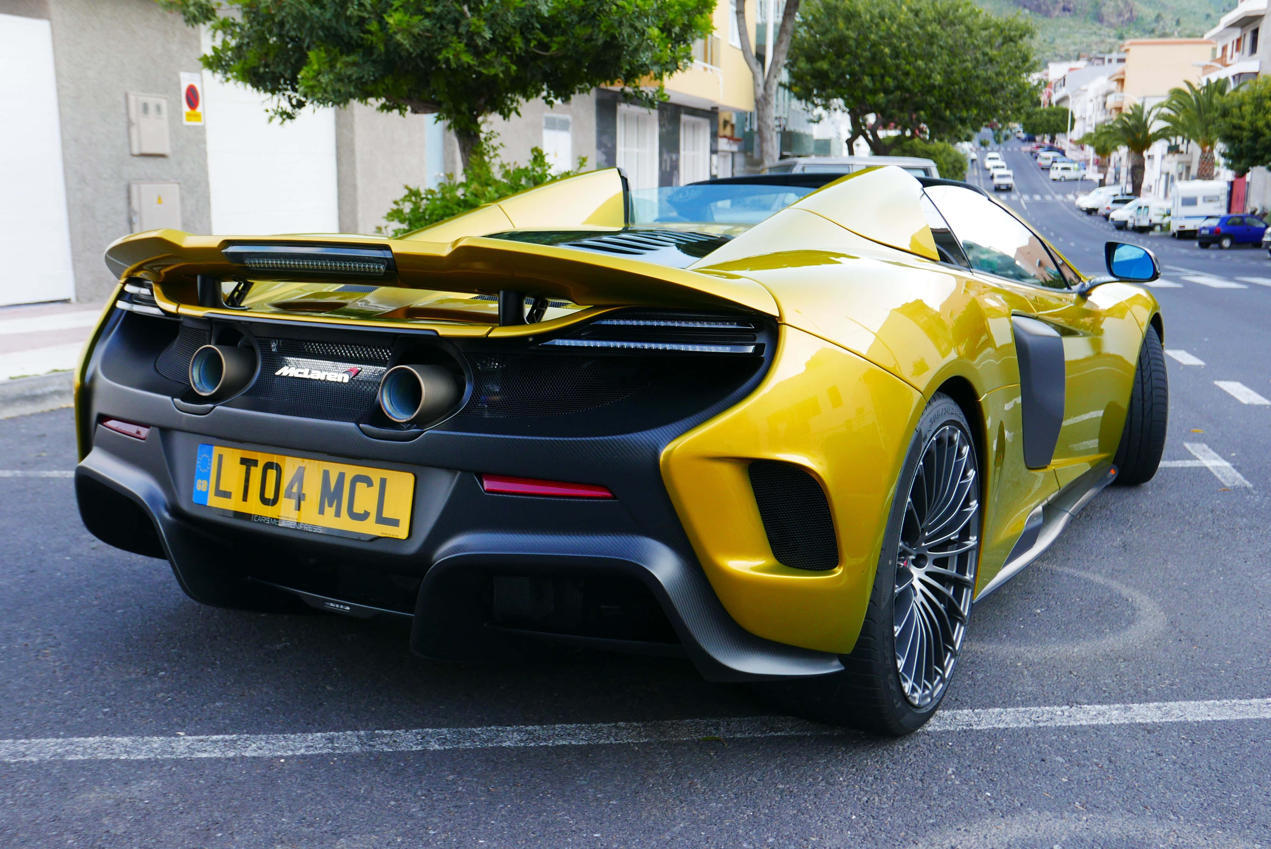 McLaren 675LT Spider, vibrant yellow, sunlit coastal street, 4K Desktop Wallpaper