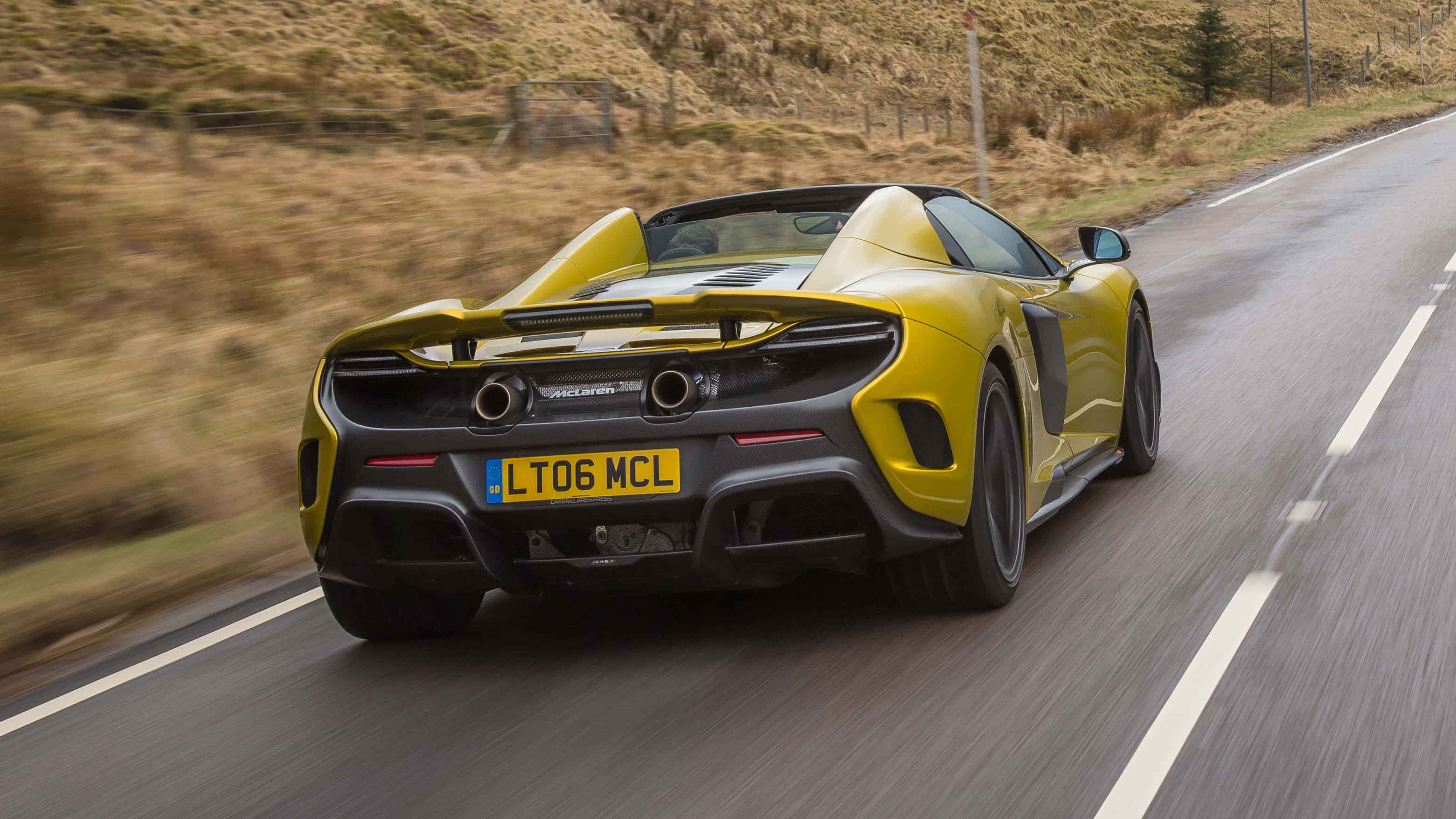 McLaren 675LT Spider, vibrant yellow, winding rural road, 2K Desktop Wallpaper