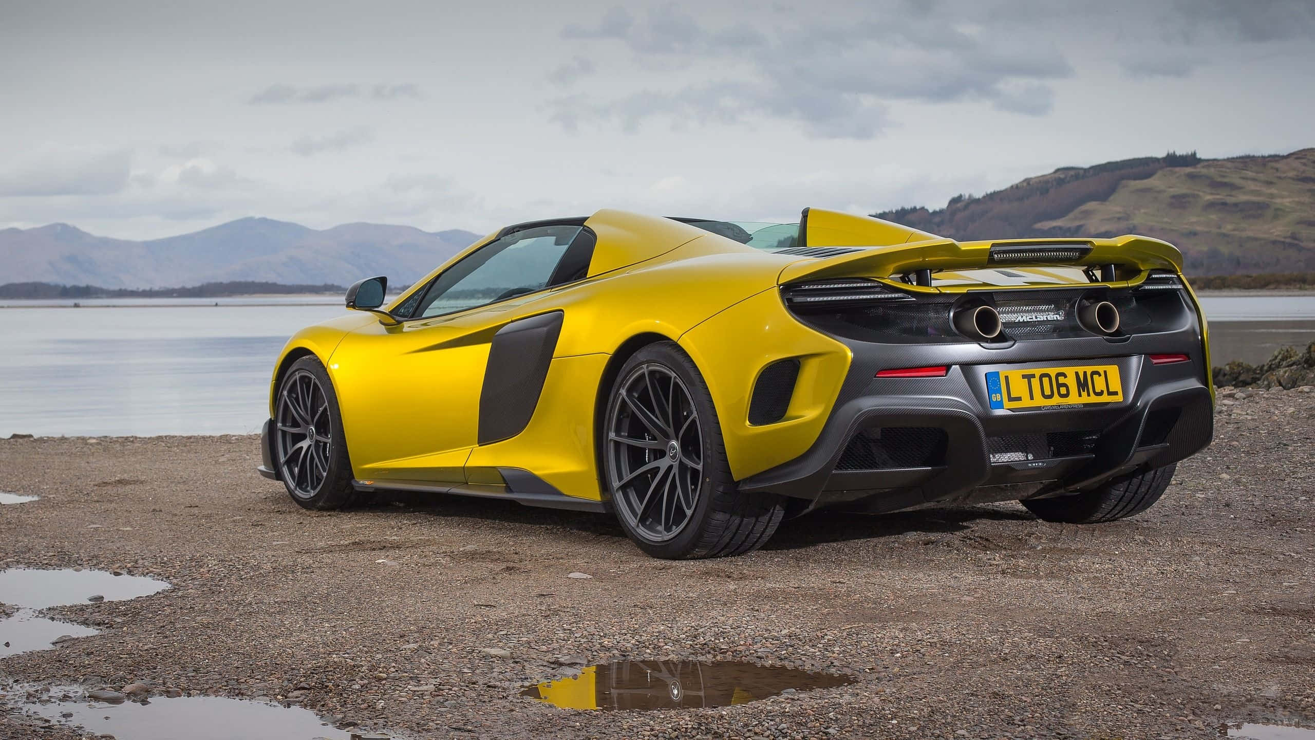 McLaren 675LT, vibrant yellow, wet pebble beach, 2K Desktop Wallpaper