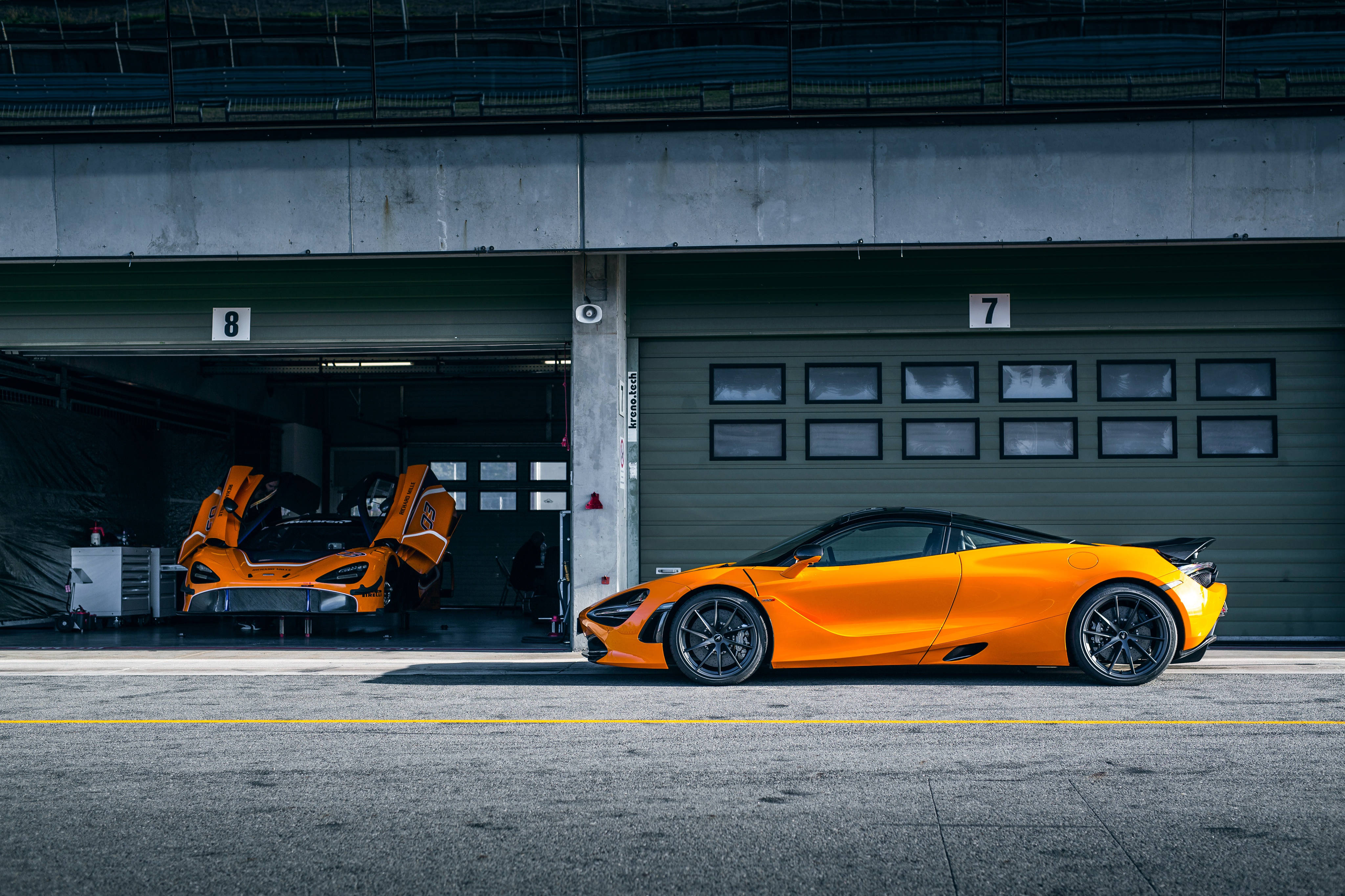 McLaren 720s, vibrant orange, concrete garage bay, 4K Desktop Wallpaper