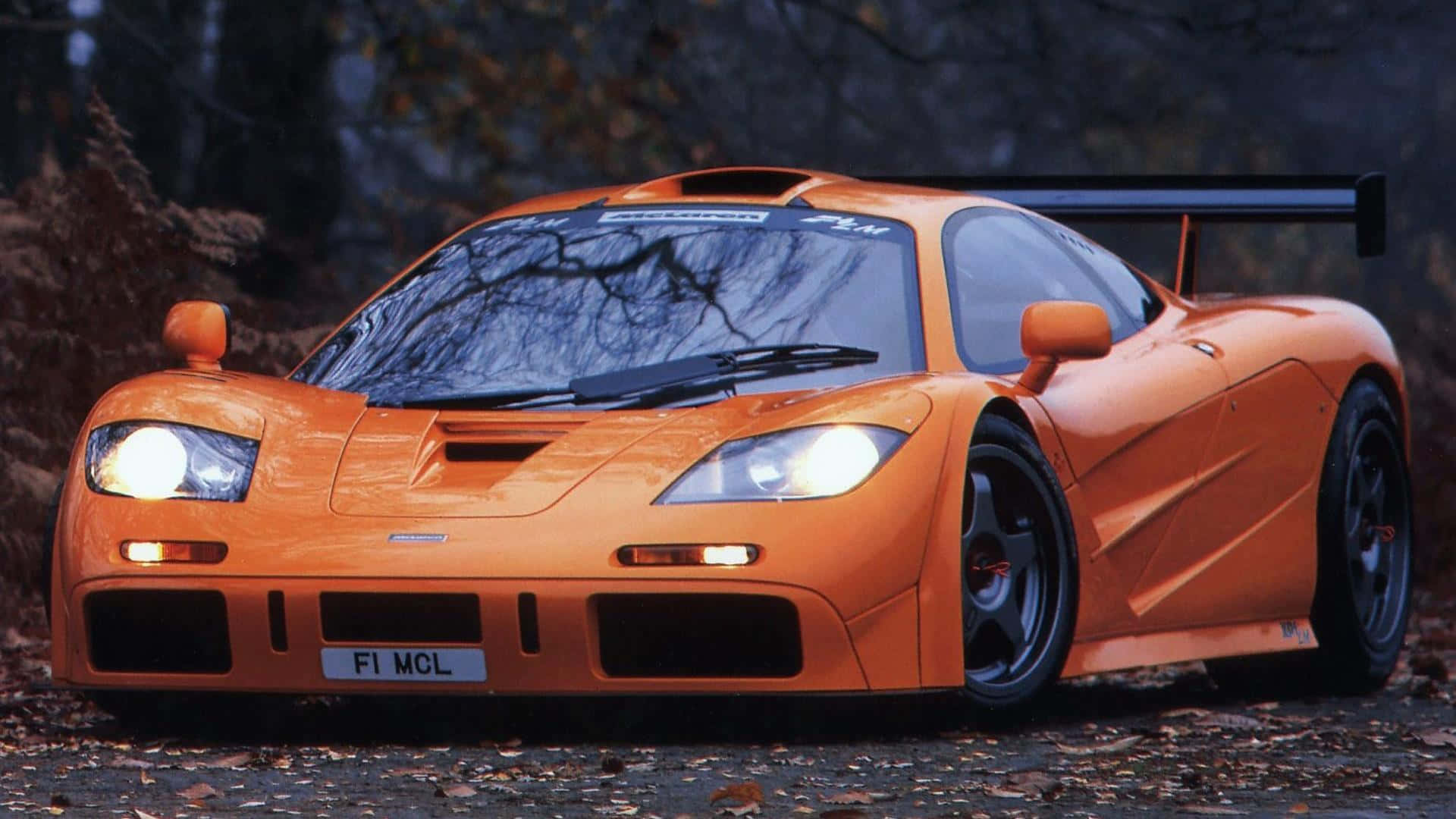 McLaren F1, vibrant orange, glowing headlights, Full HD Desktop Wallpaper