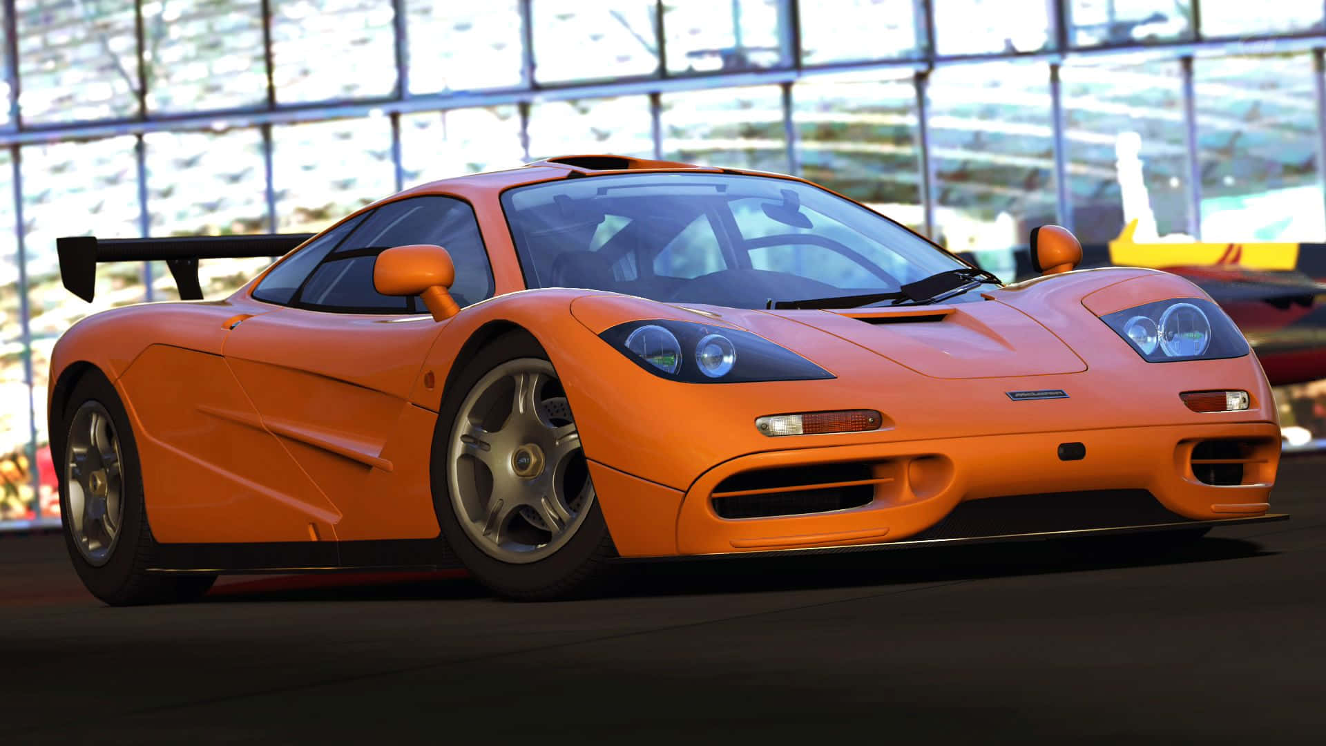 McLaren F1, vibrant orange, modern glass-walled garage, Full HD Desktop Wallpaper
