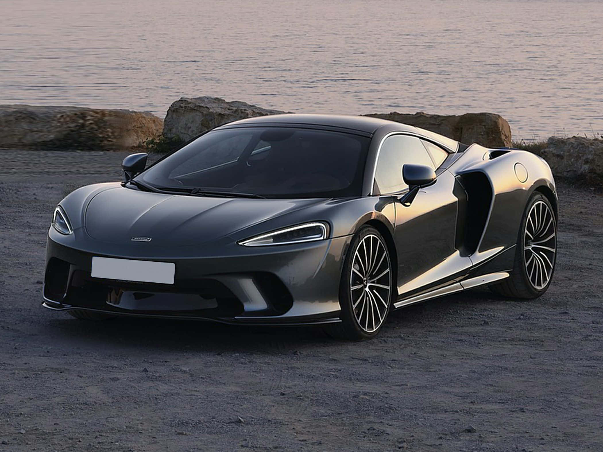 McLaren GT, sunset, rocky shore, Full HD Desktop Wallpaper