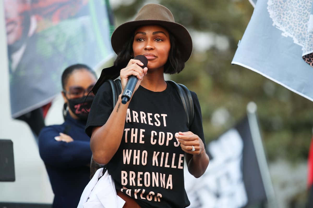 Meagan Good, brown hat, black tshirt with white text, SD Desktop Wallpaper