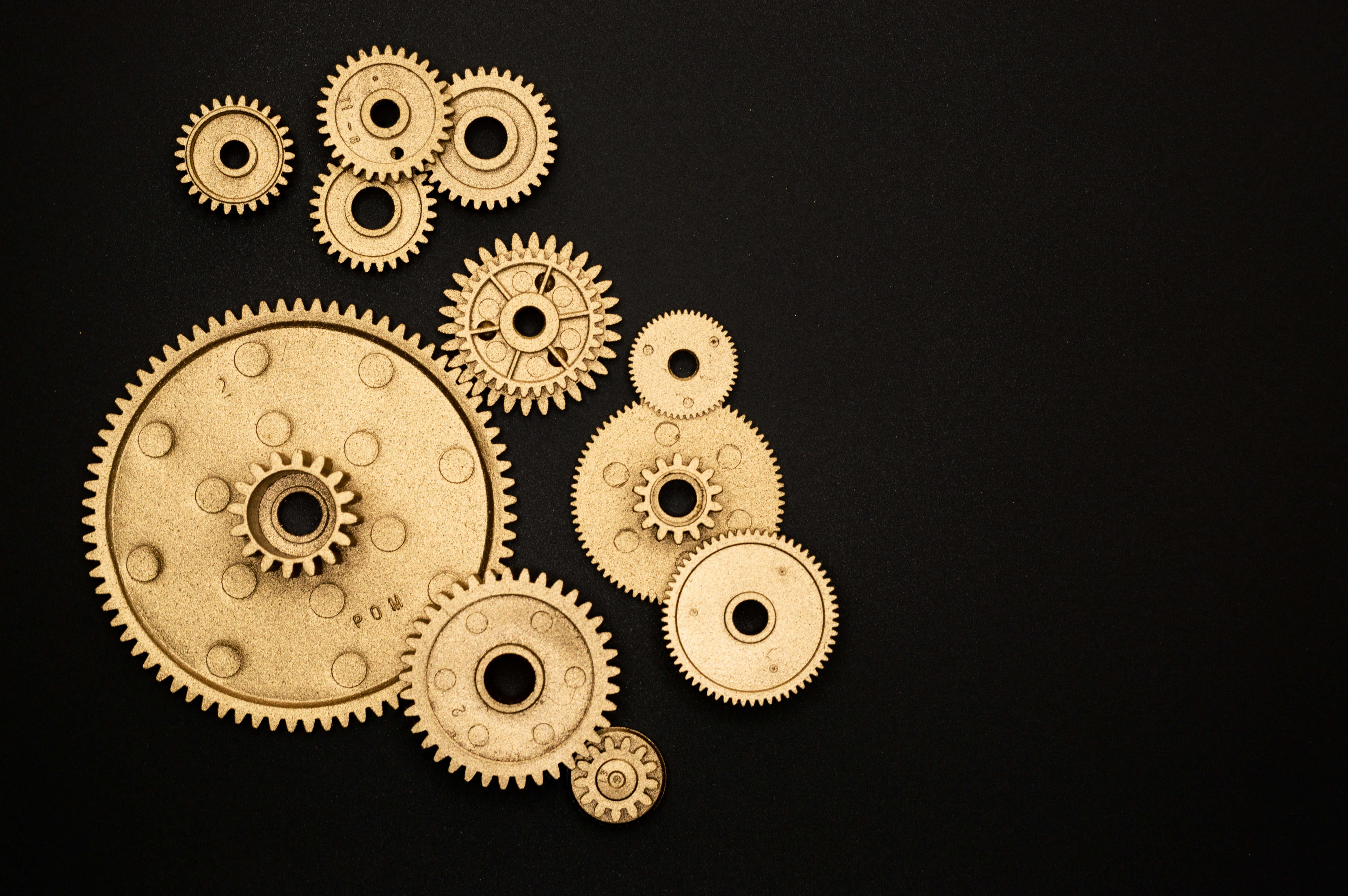 golden gears, black background, soft lighting, 5K Desktop Wallpaper