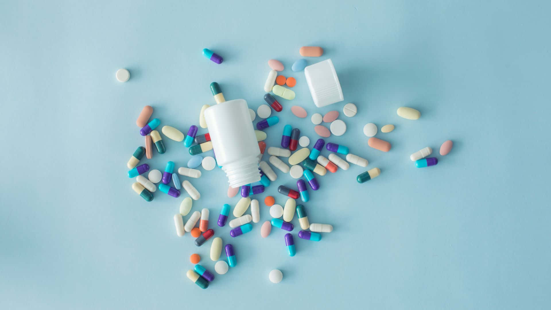 white pill bottle, colorful pills, soft blue background, Full HD Desktop Wallpaper