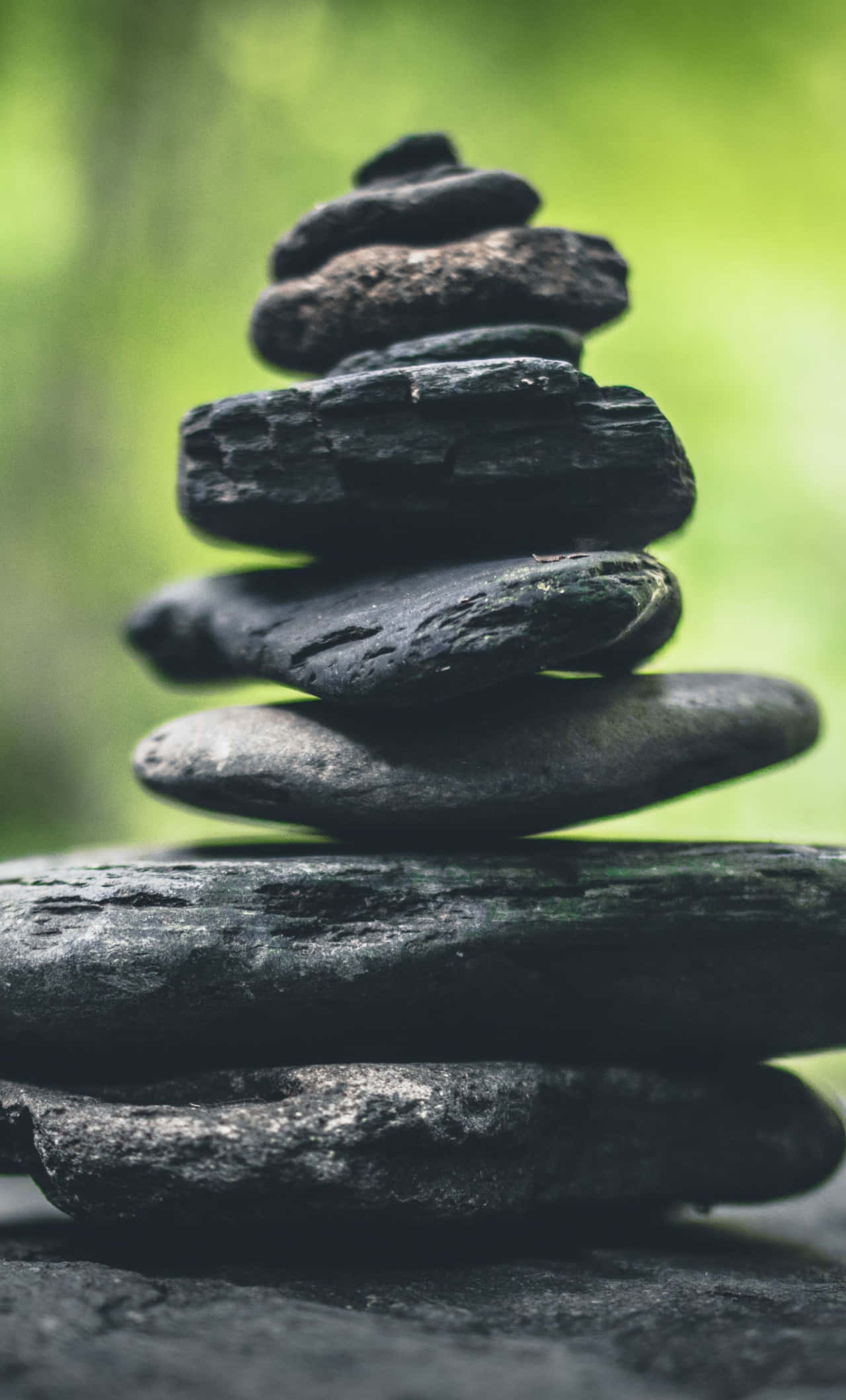 Meditation iPhone, dark gray river stones, soft green forest backdrop, Full HD Phone Wallpaper