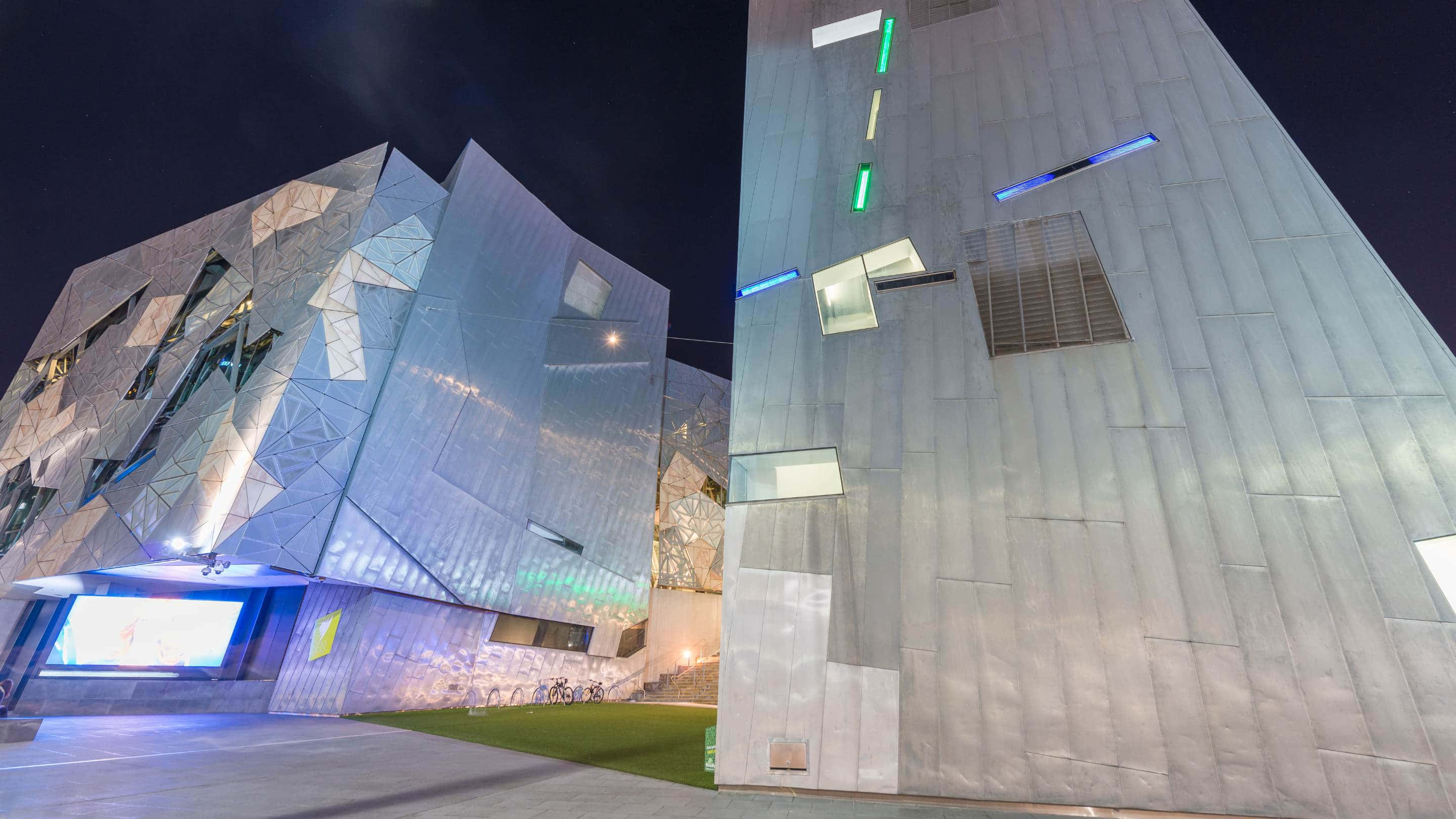 Melbourne Federation Square, geometric metallic panels, glowing blue lights, 2K Desktop Wallpaper