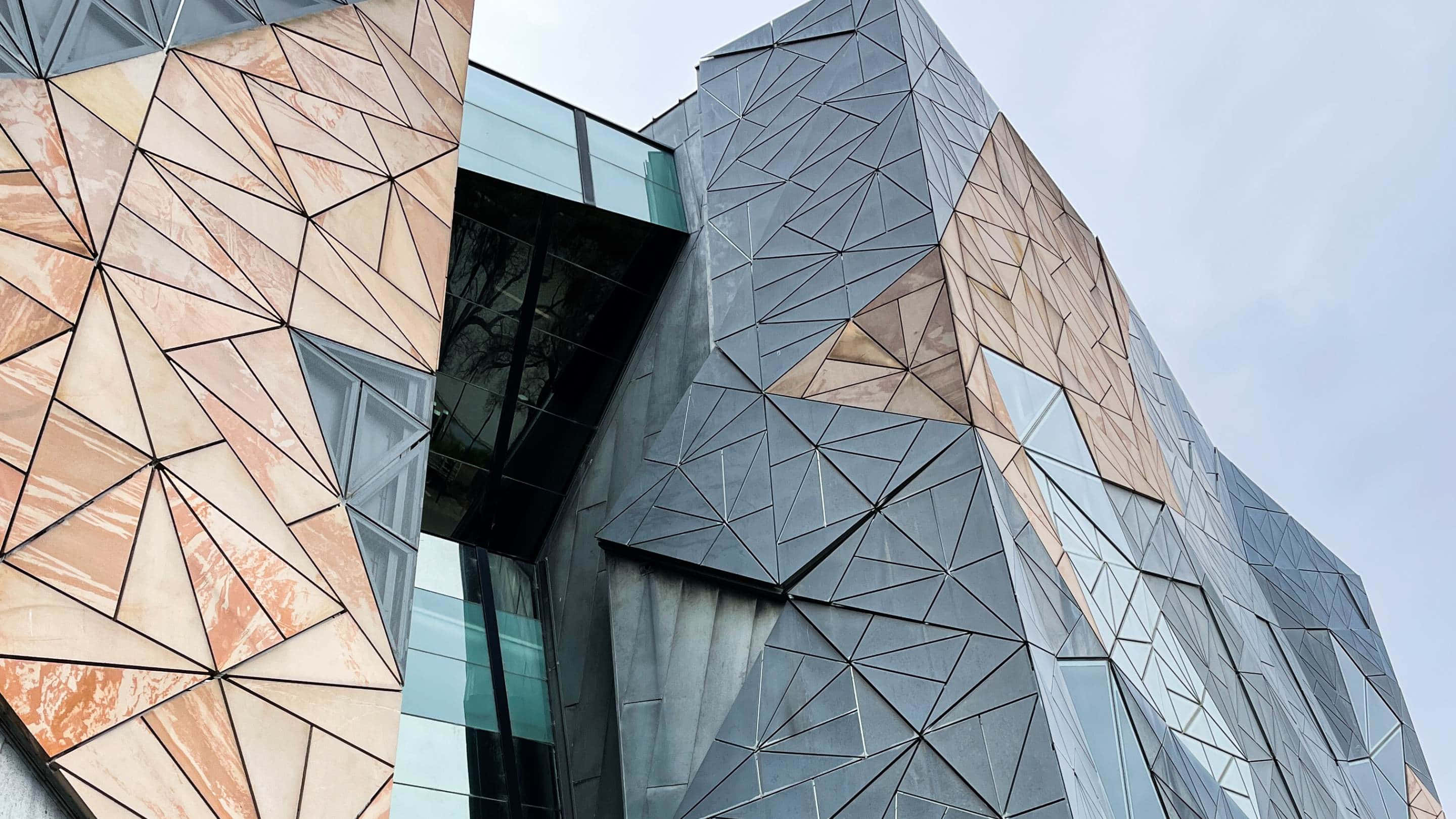 Melbourne Federation Square, geometric copper and gray metallic panels, overcast sky, 2K Desktop Wallpaper