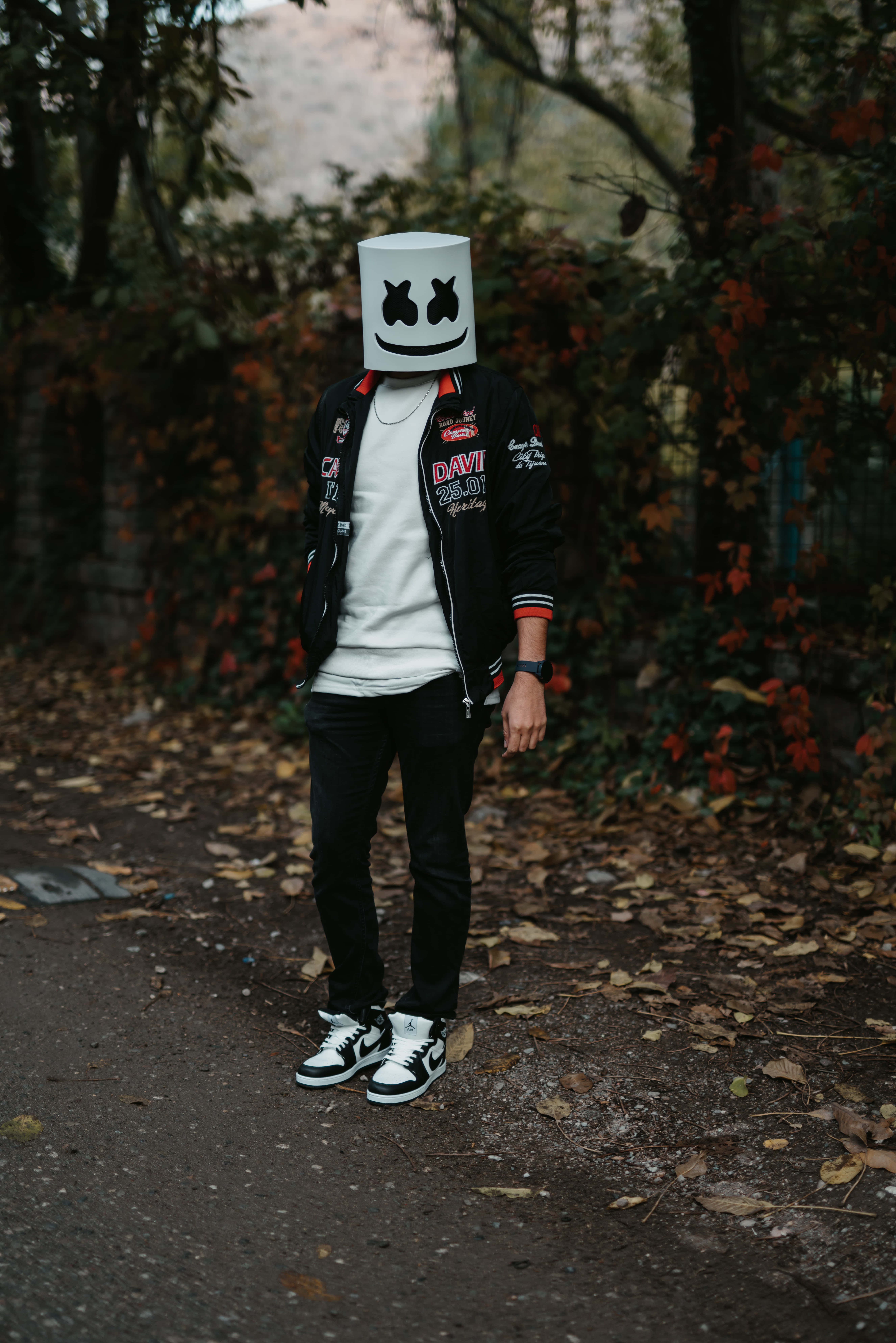 white marshmallow mask, leaf-strewn path, autumn trees, 8K Phone Wallpaper