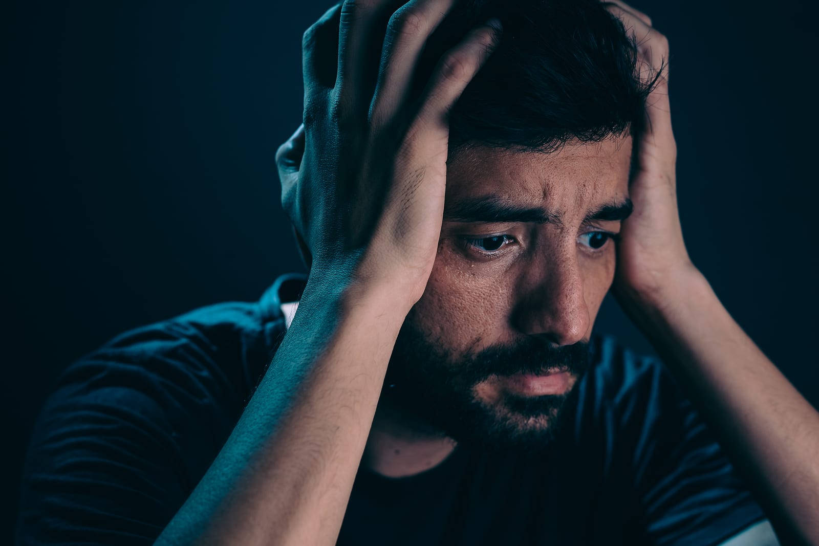 anxious man with beard, cool blue lighting, dark background, HD Desktop Wallpaper