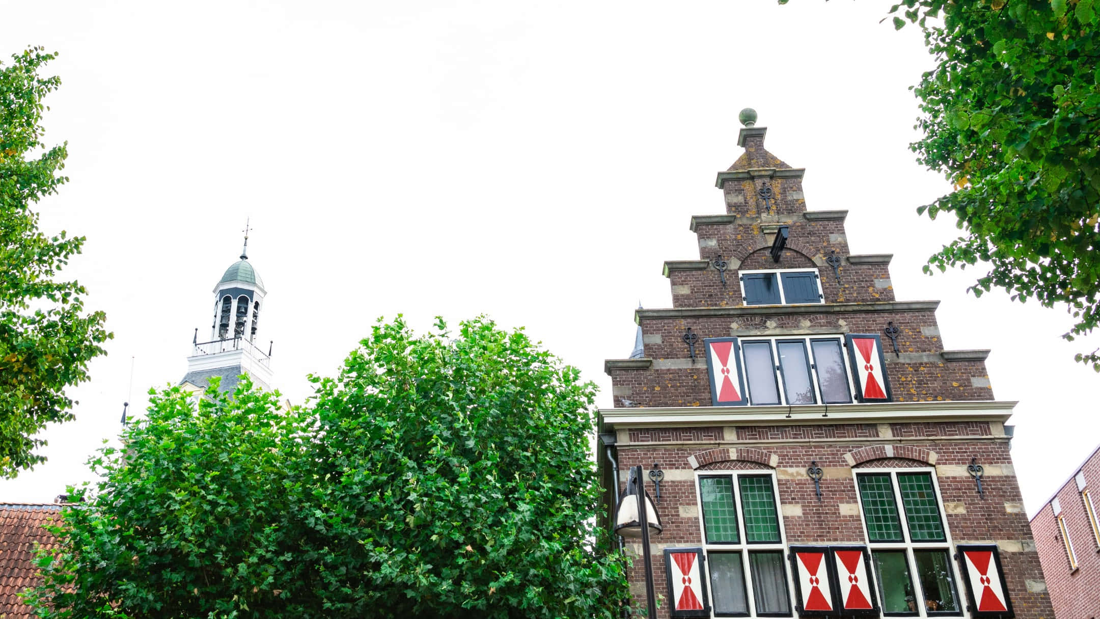 Meppel, historic Dutch gabled house, red and white flags, Full HD Desktop Wallpaper