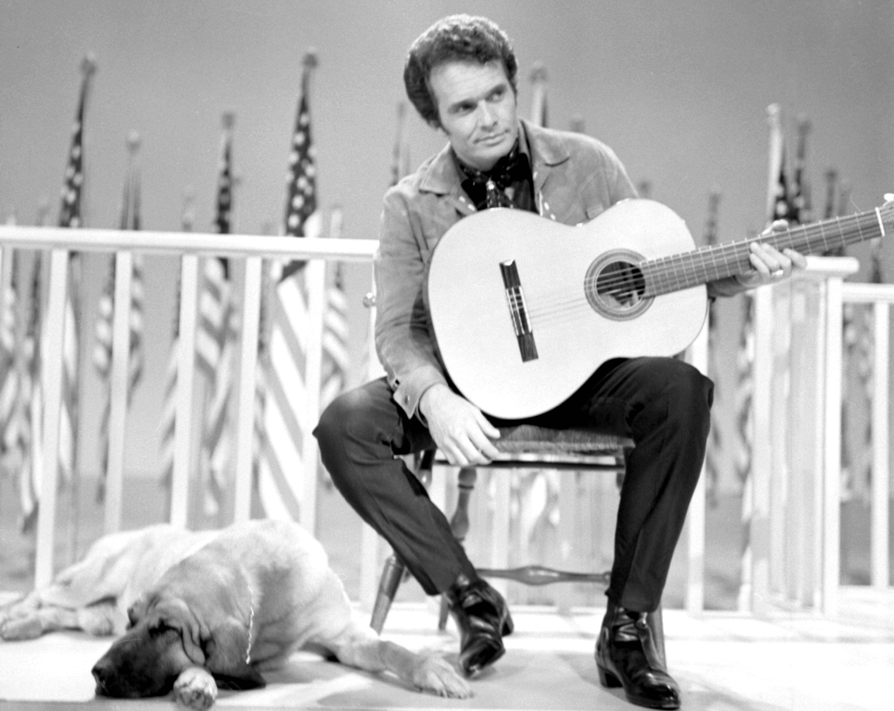 Merle Haggard, acoustic guitar, American flags, 2K Desktop Wallpaper