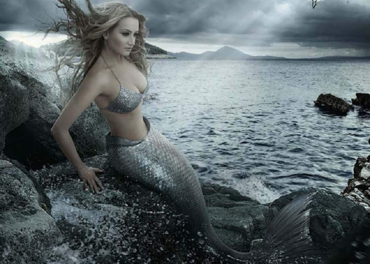 silver-scaled mermaid, flowing blonde hair, stormy coastal rocks, SD Desktop Wallpaper