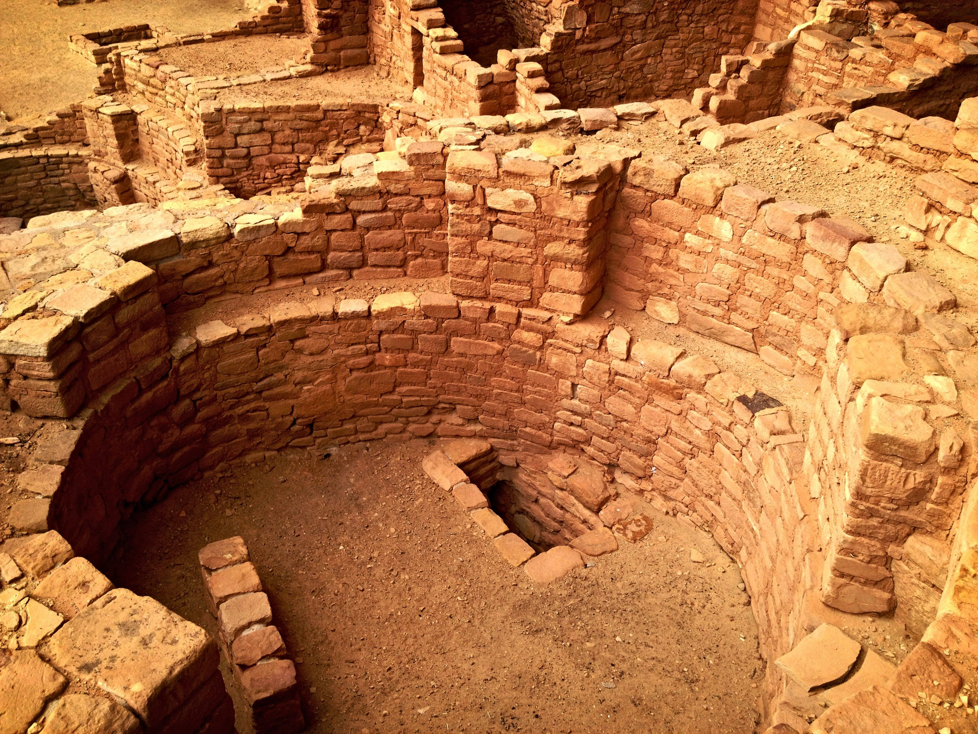 Mesa Verde, ancient circular stone ruins, sunlit adobe walls, 2K Desktop Wallpaper