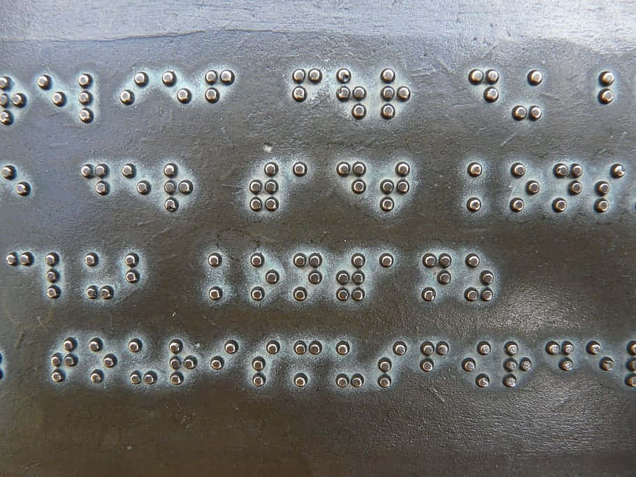 braille dots, dark textured metal surface, subtle light reflections, SD Desktop Wallpaper