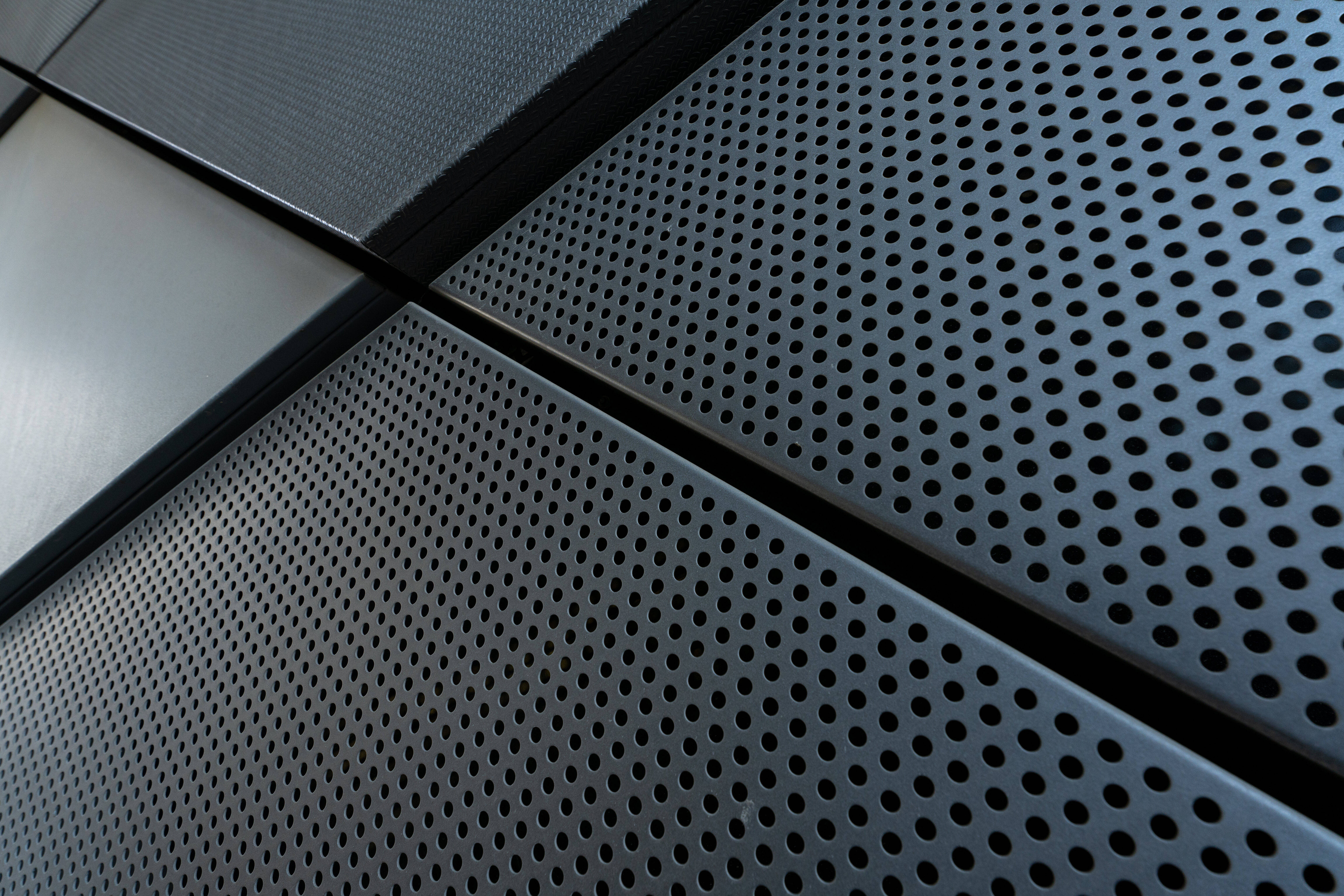 metal texture holed, geometrically arranged perforated metal panels, cool gray tones, 5K Desktop Wallpaper
